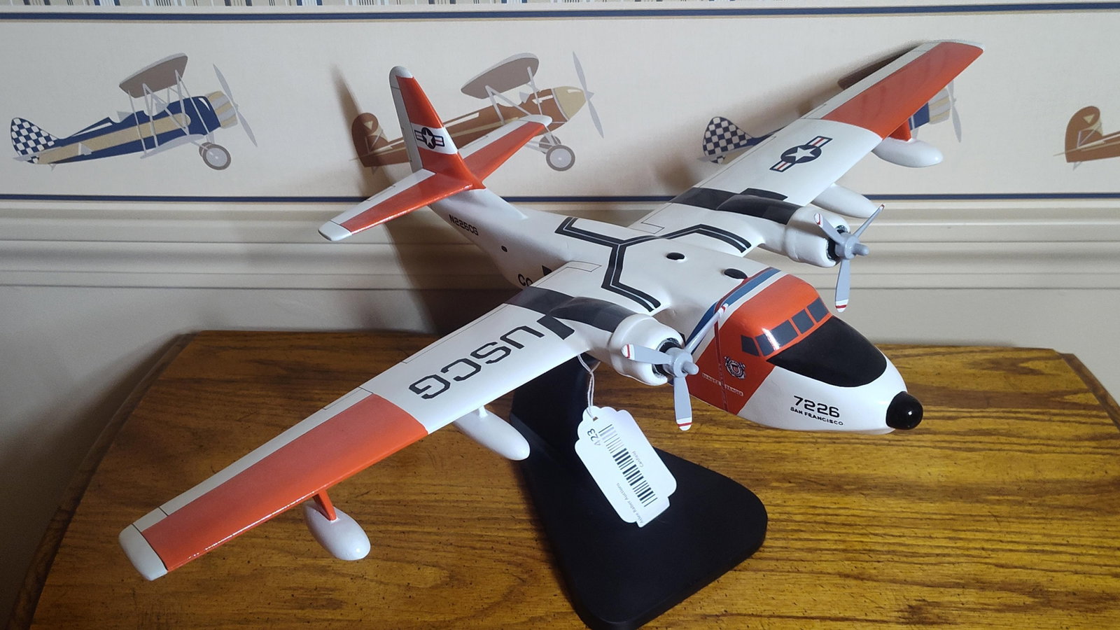 Grumman HU-16 Albatross US Coast Guard Model: This is a desktop display model of a Grumman HU-16 Albatross twin-engine amphibious flying boat, decorated in United States Coast Guard livery. The model is constructed from hand-carved wood, likely m