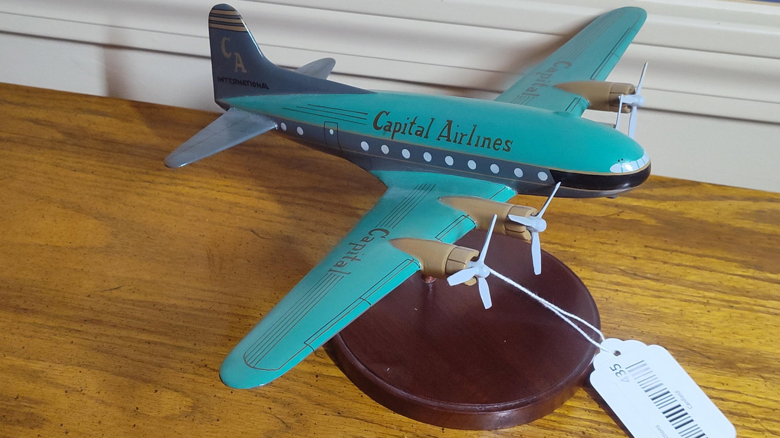 Capital Airlines 4-Engine Propeller Aircraft Model: This is a static desktop display model of a four-engine propeller-driven aircraft, configured in the livery of Capital Airlines. The airframe design corresponds to a Douglas DC-4 or DC-6 transport