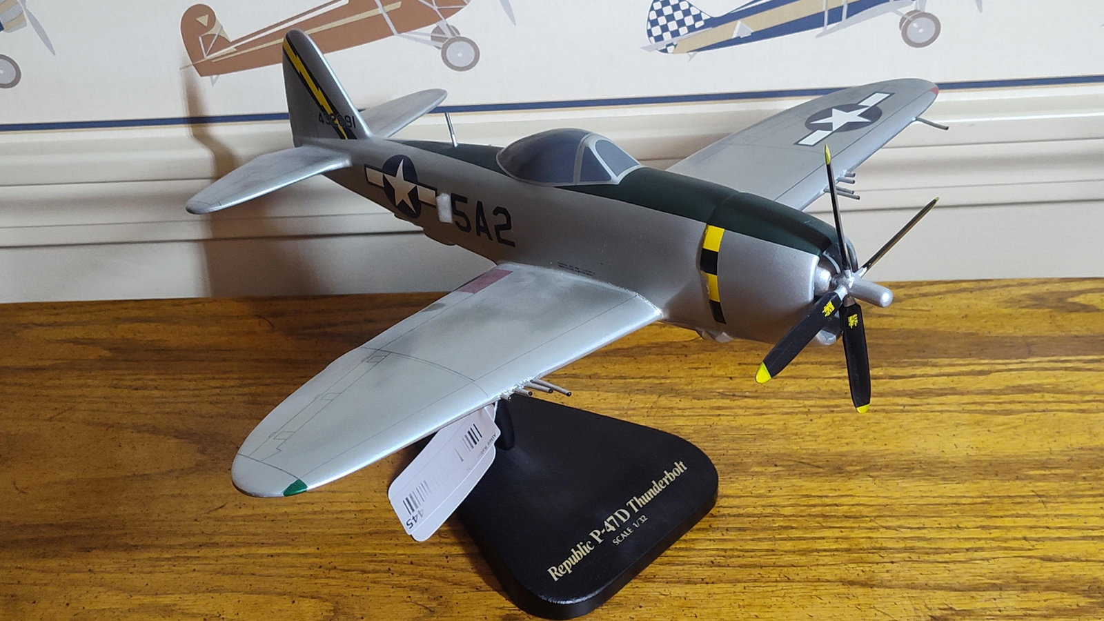 Republic P-47D Thunderbolt 1/32 Model Aircraft: This is a professional 1/32 scale display model of a World War II Republic P-47D Thunderbolt fighter aircraft. The model is constructed of hand-carved and hand-painted mahogany wood, a style typical o