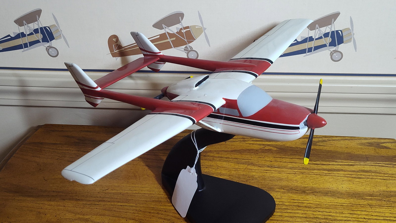 Cessna 337 Skymaster Style Desktop Display Model: Desktop display model of a twin-engine aircraft in the style of a Cessna 337 Skymaster. The model features a distinctive twin-boom and push-pull engine configuration, including one tractor propeller a