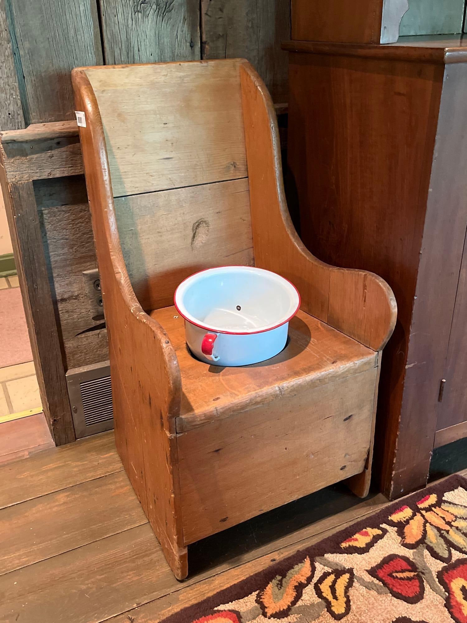 American Pine Child Potty Chair w/ Enamelware Pot: Child's commode or potty chair in the American Primitive style, dating from the late 19th to early 20th century. The chair is constructed from solid pine planks with utilitarian nail joinery. The