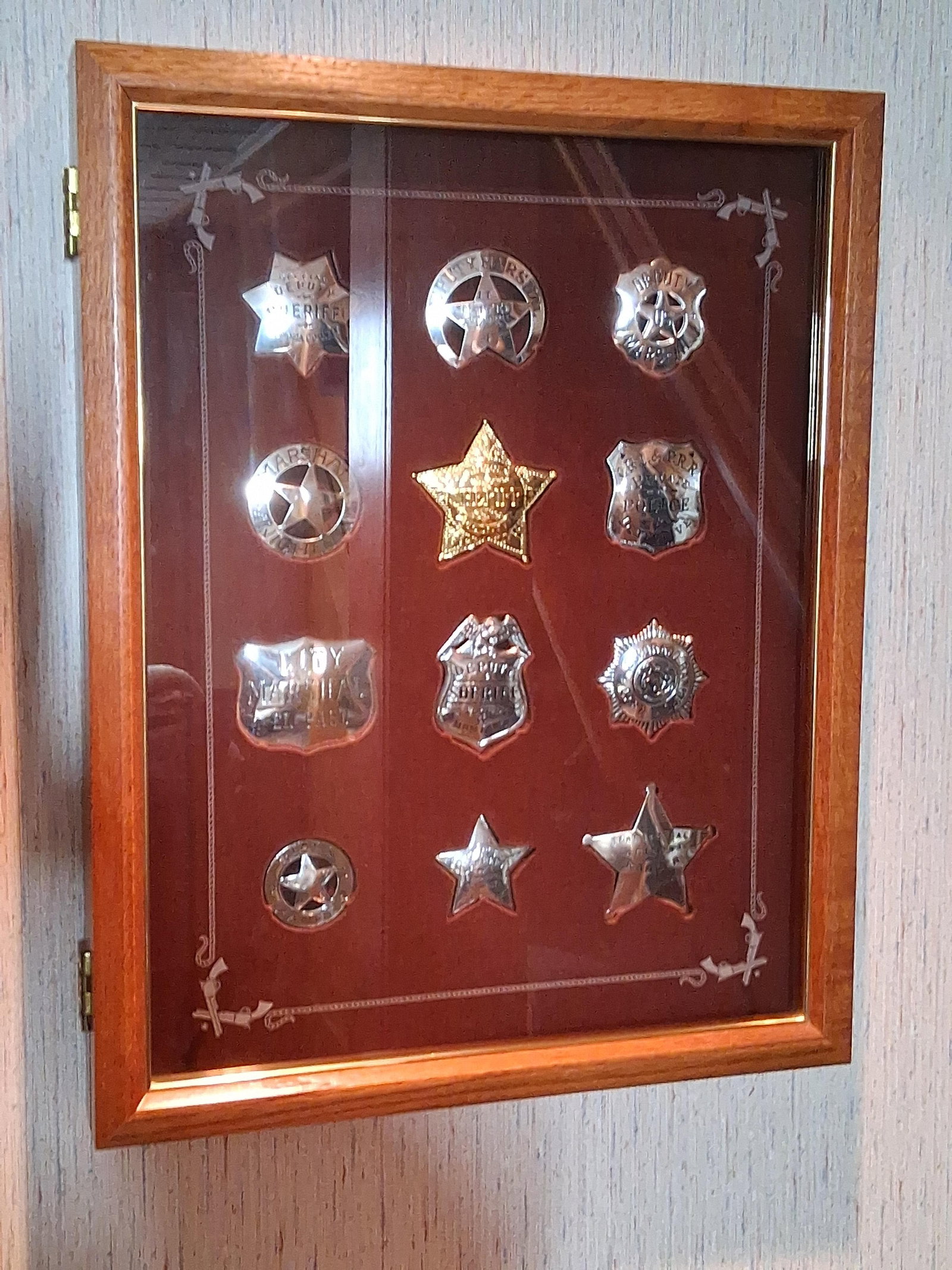 Franklin Mint Great Western Lawmen Badge Set: A collection of law enforcement-themed commemorative badges presented in a custom wooden shadow box. Based on visual characteristics and market consensus, this set is identified as The Official Badges