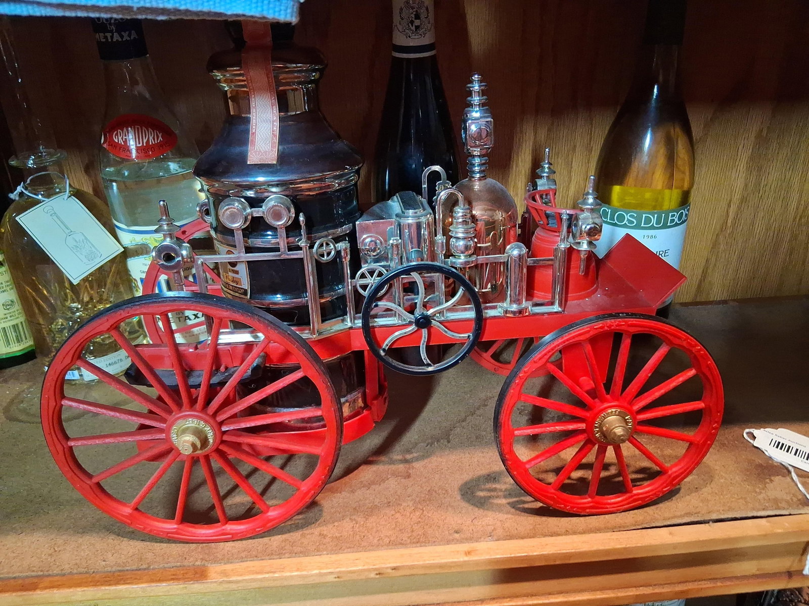 Jim Beam 1867 Mississippi Fire Engine 313 Decanter: James B. Beam Distilling Co. novelty whiskey decanter modeled after an 1867 Mississippi steam-powered fire engine. The assembly features a central glazed ceramic boiler-shaped decanter mounted on a re