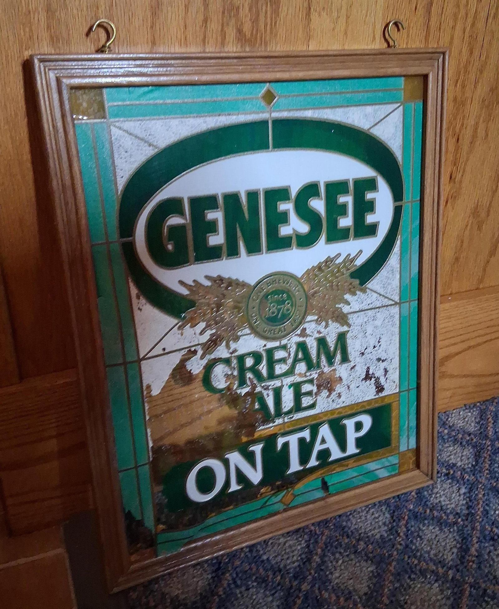 Vintage Genesee Cream Ale On Tap Bar Mirror: This vintage advertising piece is a framed bar mirror for Genesee Cream Ale, a product of the Genesee Brewing Company of Rochester, New York. The sign features a reverse-printed design on glass with a