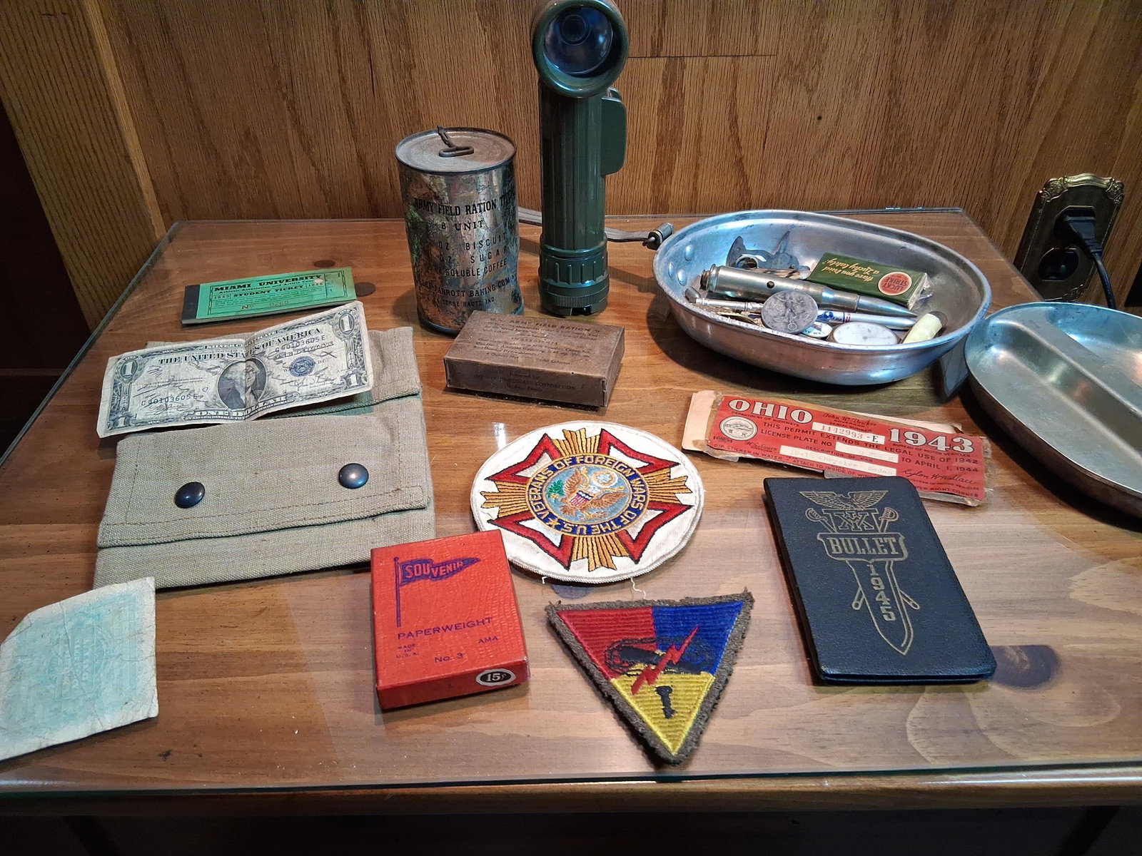 WWII US Military Field Gear, Insignia & Ephemera: A diverse collection of United States military and civilian items dating from approximately 1939 to 1946. Field equipment includes an olive drab plastic angle-head flashlight, characteristic of the