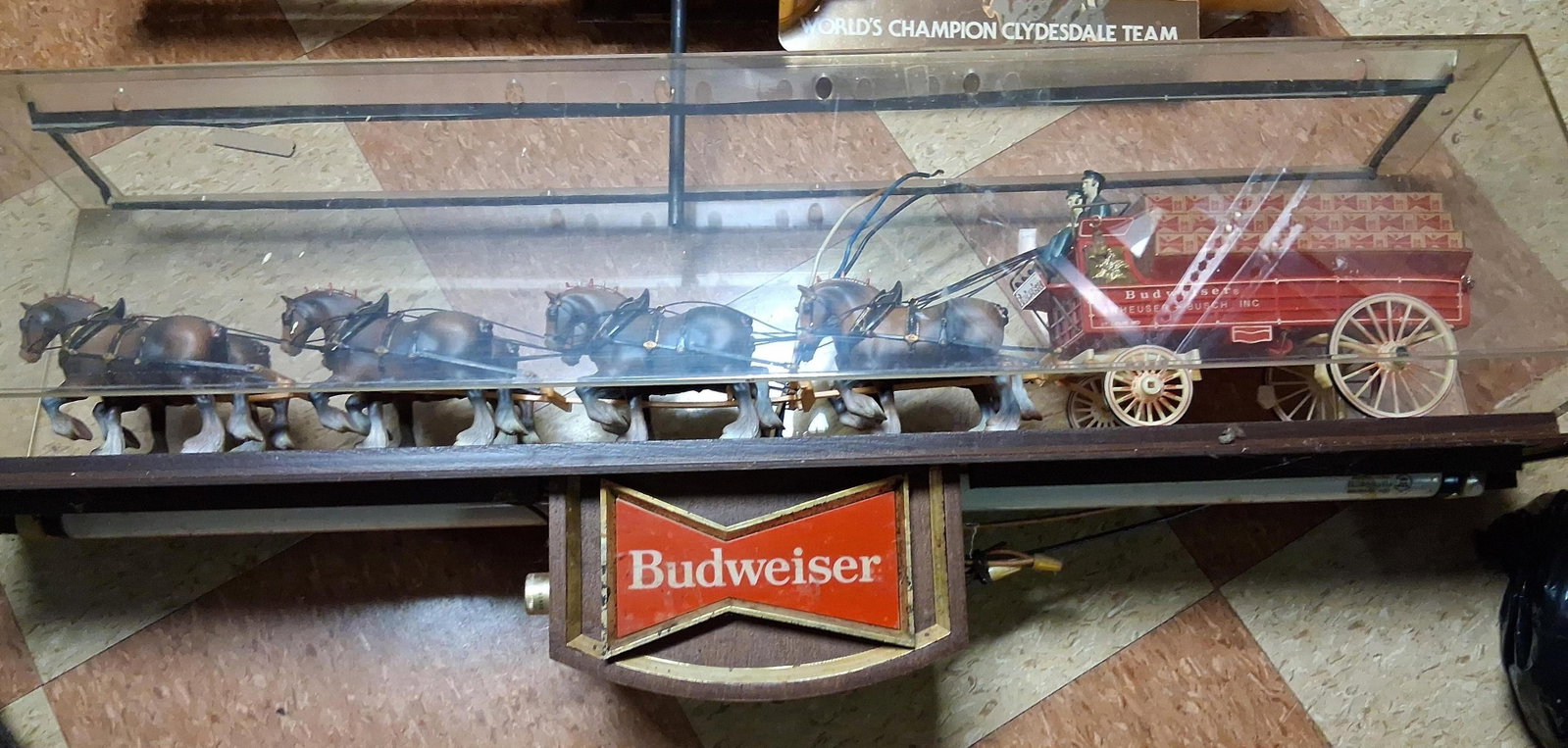 Budweiser World's Champion Clydesdale Lighted Sign: A vintage Budweiser lighted advertising display featuring the World's Champion Clydesdale Team. The piece consists of a three-dimensional diorama housed within a clear acrylic case, depicting a red