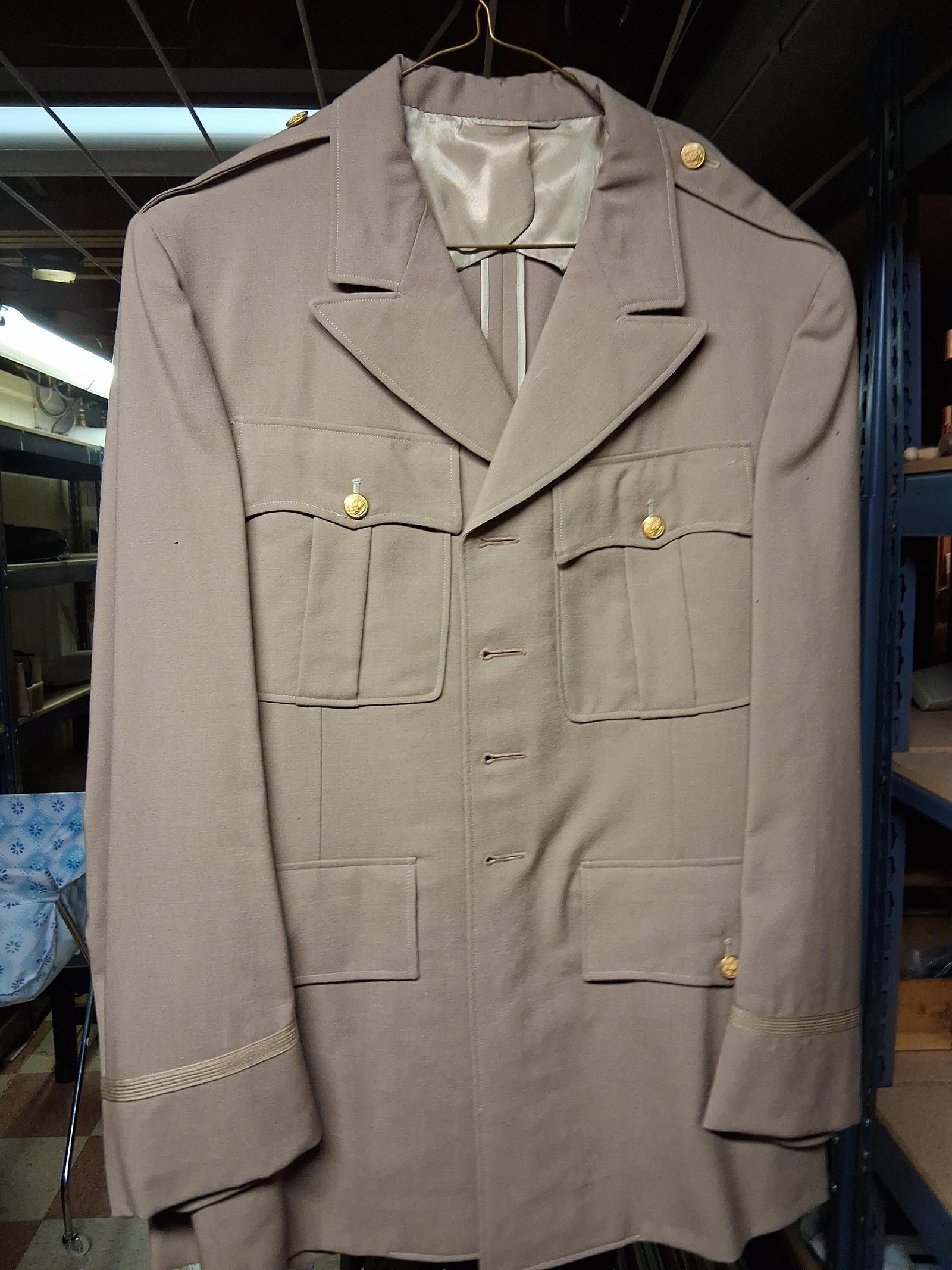 WWII US Army Officer Khaki Service Uniform Jacket: This is a United States Army officer summer service coat, typically referred to as a khaki service jacket, dating to the World War II era. The garment is constructed from a khaki-colored gabardine
