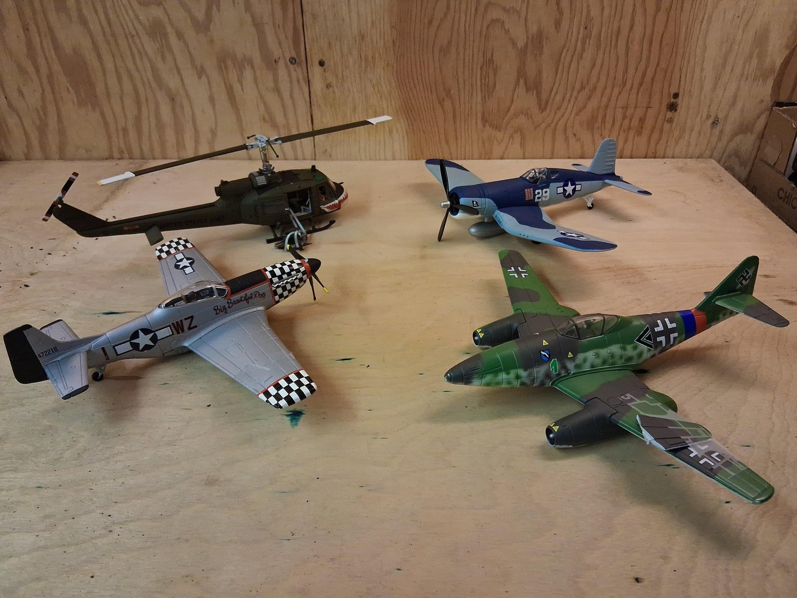 Built-Up Plastic Military Aircraft & Helicopter: An assortment of assembled plastic scale model military aircraft. The collection includes a Bell UH-1 Huey helicopter finished in an olive drab United States Army scheme with shark mouth nose art and