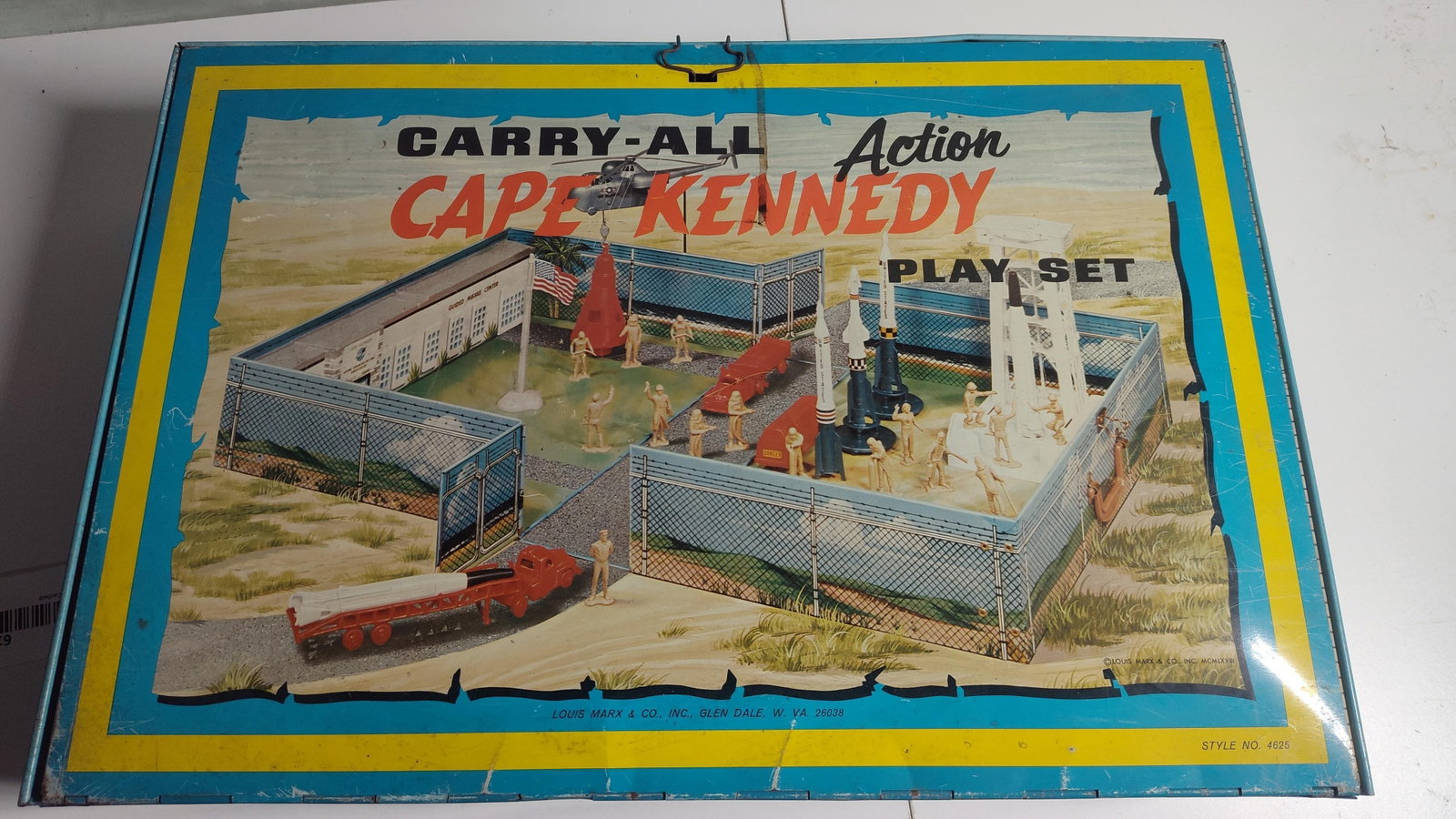Louis Marx & Co. Cape Kennedy Carry-All Play Set: This is a vintage Cape Kennedy Carry-All Action Play Set manufactured by Louis Marx & Co., Inc. in Glen Dale, West Virginia. The item consists of a lithographed tin carrying case that unfolds to serve