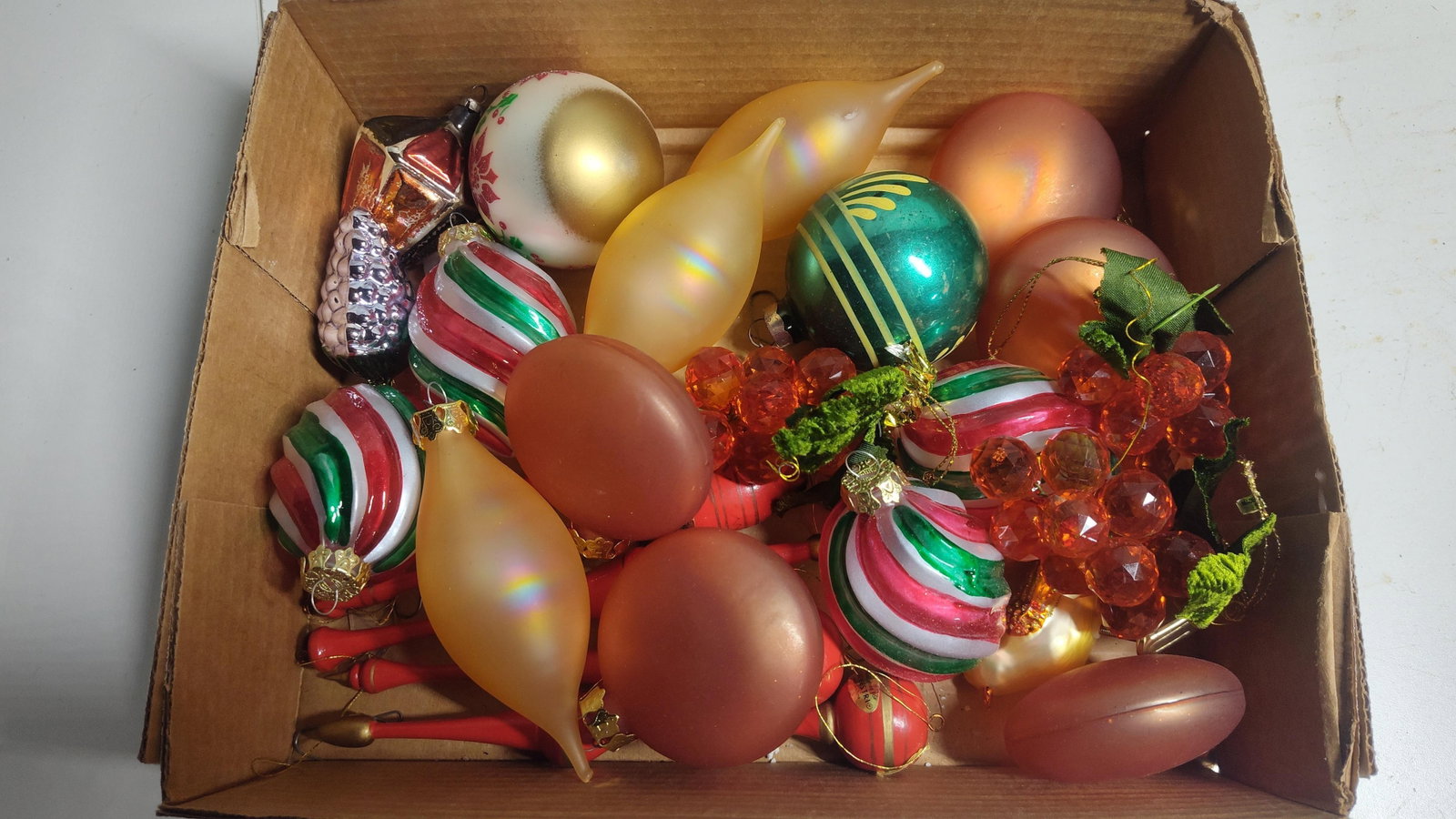Silvestri & Vtg Christmas Ornaments: This collection consists of approximately 25 Christmas tree ornaments of varying materials, styles, and periods. Included in the group are several elongated finial-style ornaments crafted from turned 