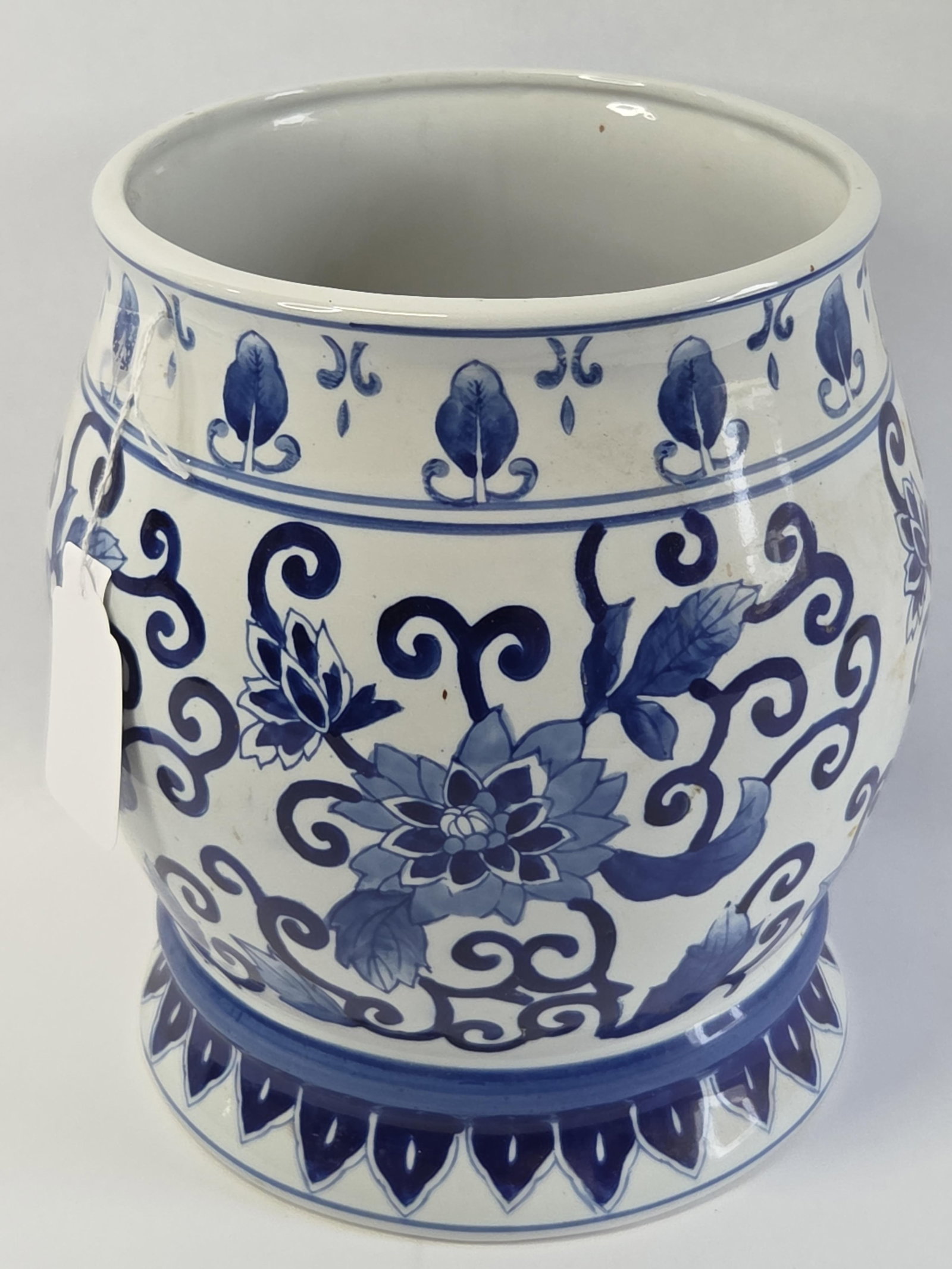 Chinoiserie Style Blue and White Porcelain Planter: 10in tall This large ceramic planter is constructed of white glazed porcelain and decorated with hand-painted underglaze blue motifs. The vessel features a bulbous, rounded body that tapers to a