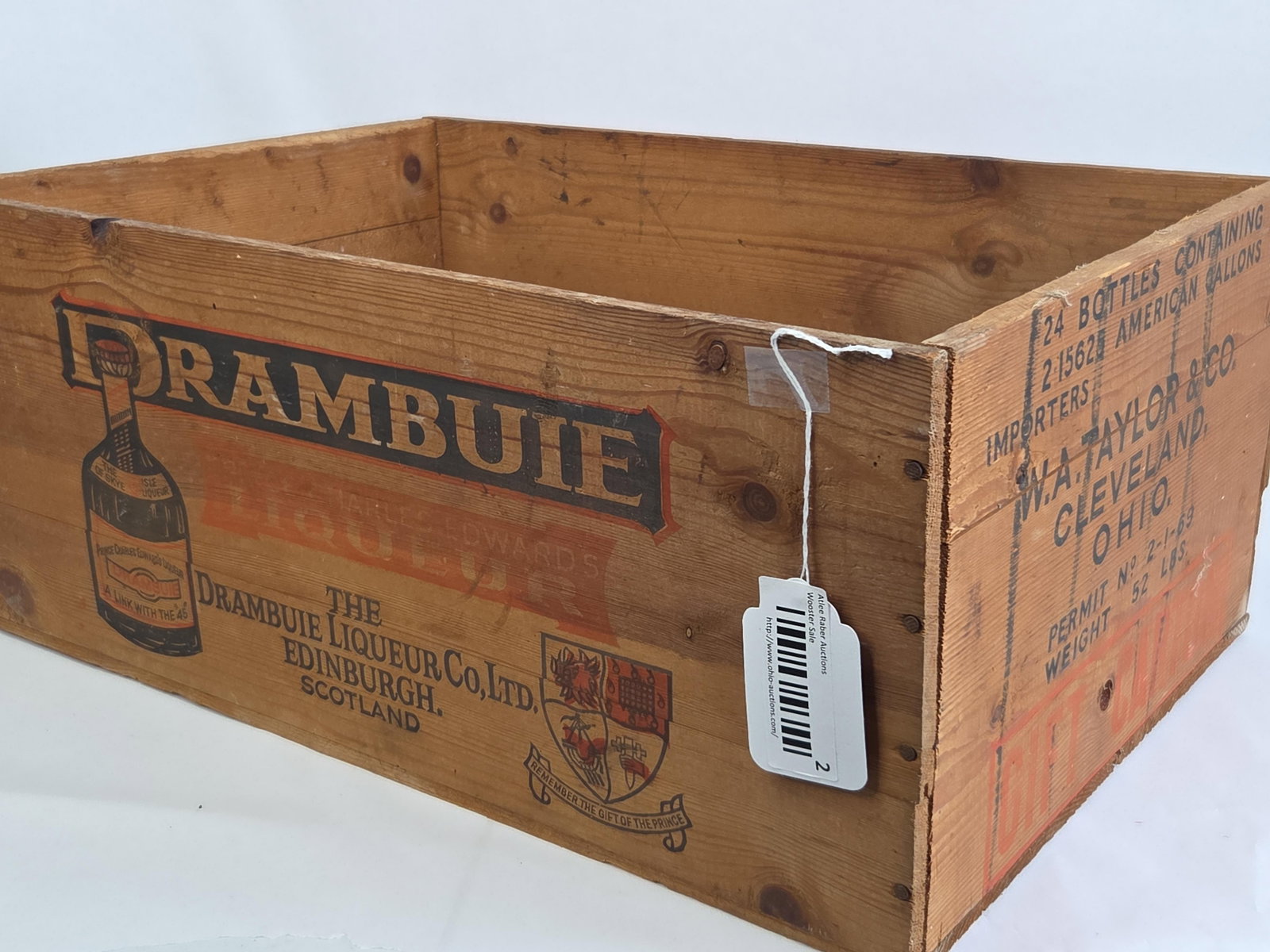 Drambuie Liqueur Wooden Shipping Crate with Cleveland Ohio Importer Marks: 21x14.25 A rectangular wooden shipping crate produced for the Drambuie Liqueur Co. Ltd. of Edinburgh, Scotland. The crate is constructed from softwood panels with nail-head assembly. Both long side