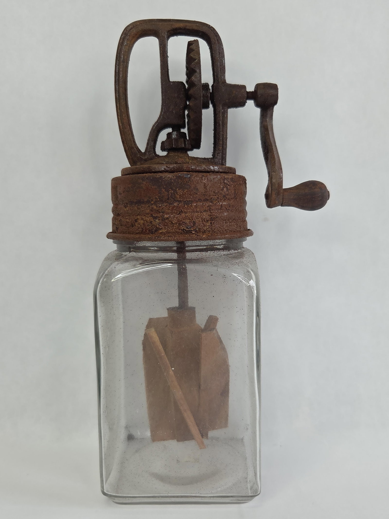 Contemporary Decorative Glass and Cast Iron Manual Butter Churn in the Style of Dazey: 11.25 in tallThis item is a contemporary decorative manual butter churn, manufactured as a reproduction of early 20th-century kitchenware in the style of Dazey. The churn features a clear glass jar