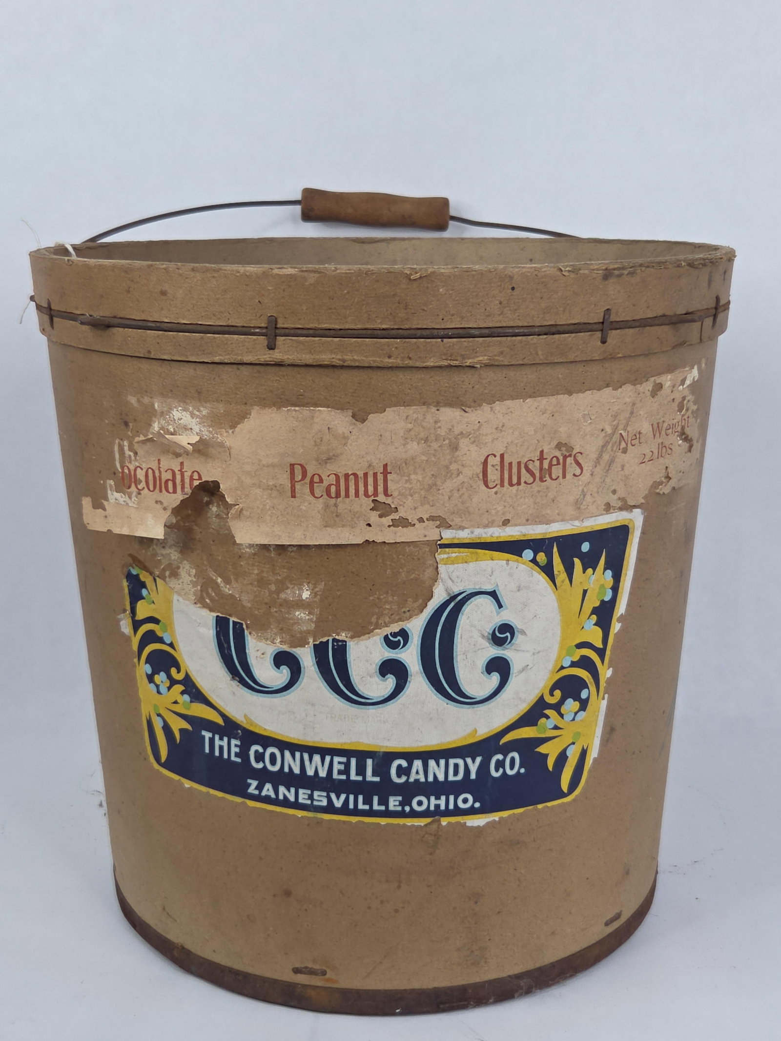 The Conwell Candy Co. Fiberboard Bulk Candy Shipping Bucket: A bulk candy shipping container produced for The Conwell Candy Co. of Zanesville, Ohio. The bucket is constructed from heavy-gauge fiberboard with a metal wire-reinforced top rim secured by metal
