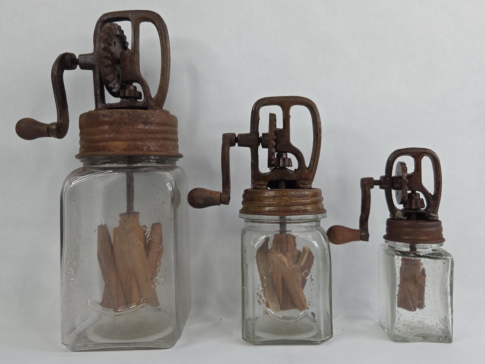 A Set of Three Decorative Graduated Glass Butter Churns in the Style of Hazel-Atlas (1 of 8)