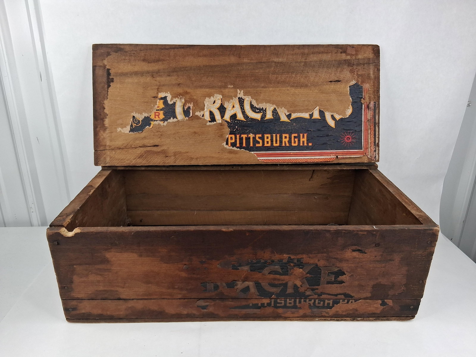 Al Racke Pittsburgh Wood Advertising Cigar Crate: This is an antique wooden advertising crate for Al Racke, an early 20th-century business based in Pittsburgh, Pennsylvania. The crate is constructed of nailed wood with a hinged lid that features two