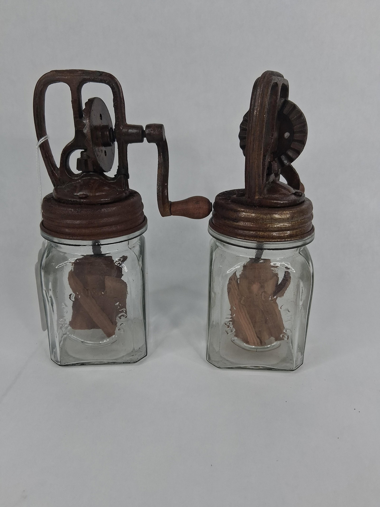 Pair Dazey Churn & Mfg. Co. Glass Butter Churns: This lot consists of a pair of hand-crank butter churns manufactured by the Dazey Churn and Mfg. Co. of St. Louis, Missouri. Each unit features a square-form glass jar with embossed text including