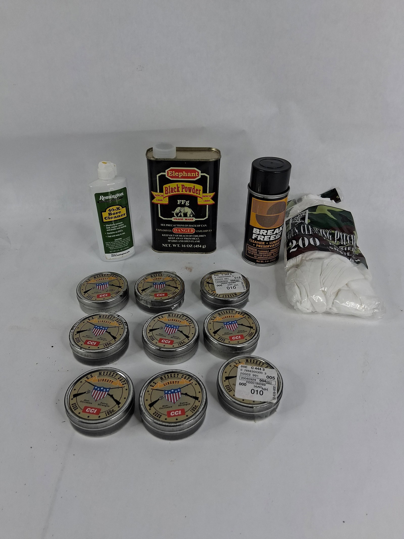 CCI & Elephant Muzzleloading & Cleaning Supplies: This lot comprises a group of muzzleloading shooting supplies and maintenance accessories. The collection includes nine individual 100-count tins of CCI U.S. Musket Caps Liberty, one 16 ounce metal