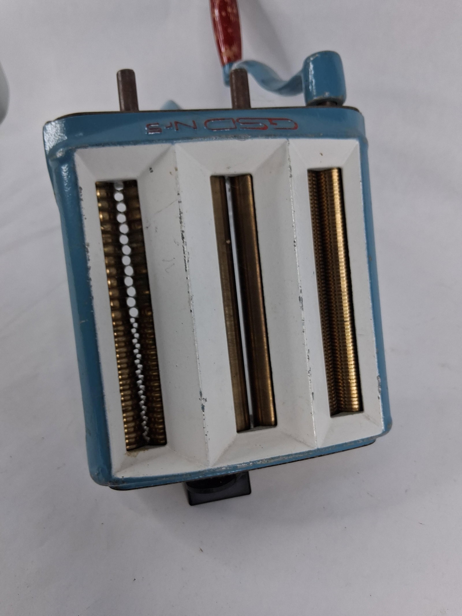 GSD Nr. 5 Pasta Machine, W. Germany: A hand-cranked pasta or noodle cutting machine manufactured by GSD (Gross and Schmidt). This model, designated as Nr. 5, features a heavy cast metal body finished in blue and white enamel-style