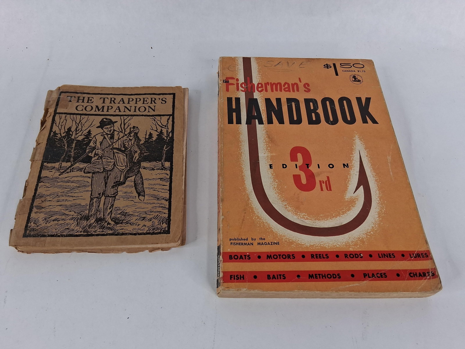 Pair Manuals: Trapper & Fisherman (1956): A pair of softcover instructional manuals concerning outdoor pursuits. The first volume is titled The Trapper's Companion, published by A. R. Harding of Columbus, Ohio. This small-format guidebook