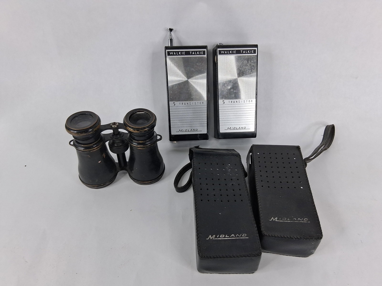 Midland 13-105B Walkie-Talkies & Field Glasses: This lot features a pair of 1960s walkie-talkies and a pair of antique-style field glasses. The walkie-talkies are Midland Model 13-105B, manufactured in Japan in 1966. These portable hand-held transc