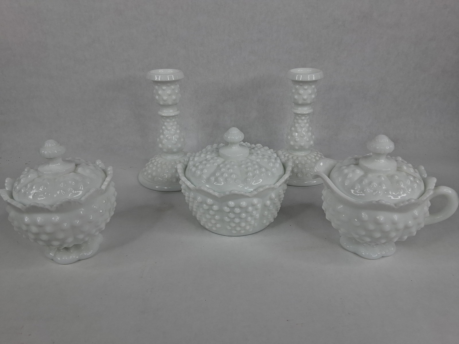 Set 5 Fenton Hobnail White Milk Glass Tableware: This set of white milk glass is produced in the Hobnail pattern by the Fenton Art Glass Company. Each piece is constructed from opaque white glass featuring regularly spaced, raised conical bumps