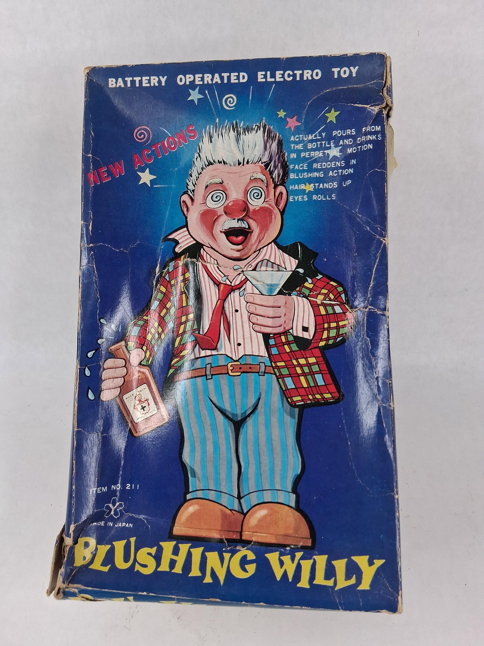 Yonezawa Japan Blushing Willy Battery Toy w/ Box: This battery-operated character toy, titled Blushing Willy (Item No. 211), was manufactured by Yonezawa in Japan during the mid-20th century. The toy is constructed with a lithographed tin body and le