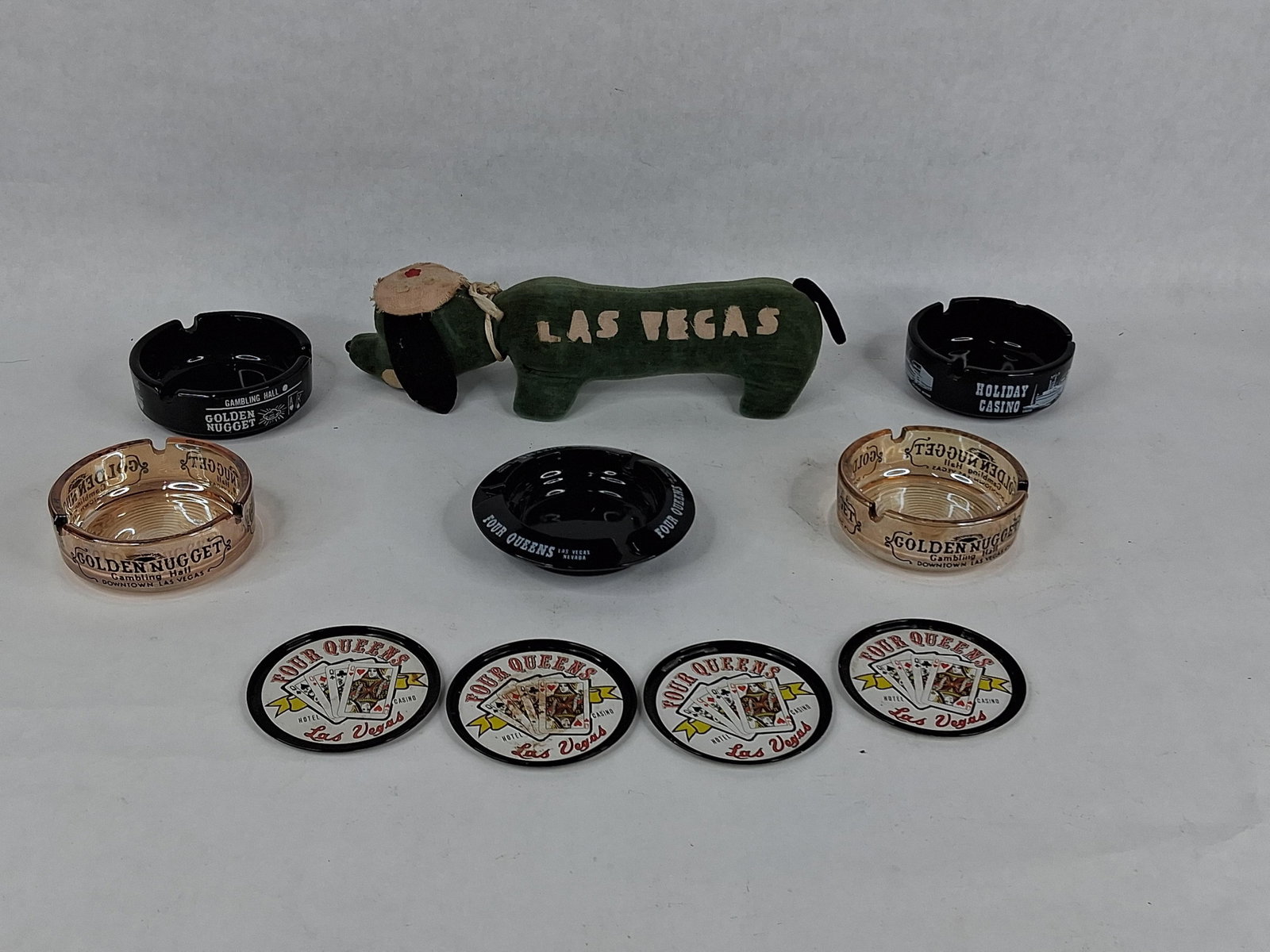 Golden Nugget & Four Queens Casino Memorabilia: This collection of Las Vegas casino memorabilia consists of various souvenir items from historic gaming establishments. The group contains amber glass ashtrays with black transfer text reading Golden