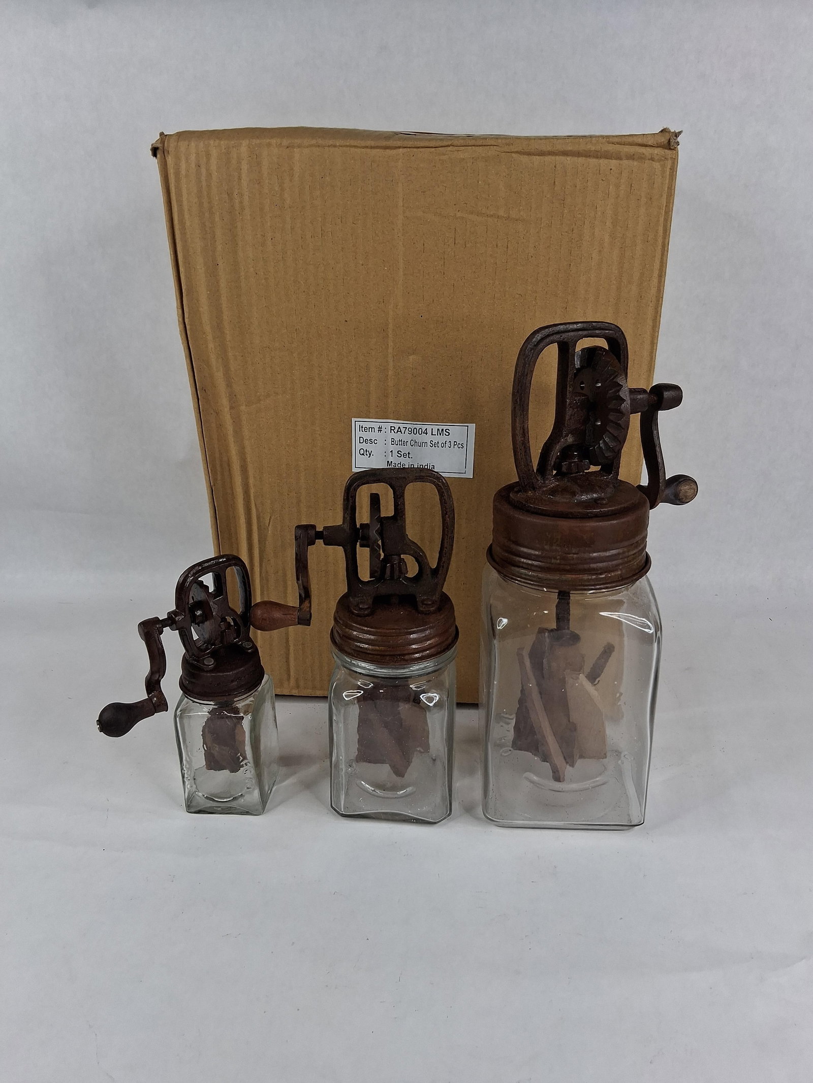 Set 3 Dazey-Style Glass Butter Churns: A graduated set of three modern decorative butter churns designed in the style of kitchenware. The collection includes small, medium, and large sizes. Each item is composed of a square-sided clear