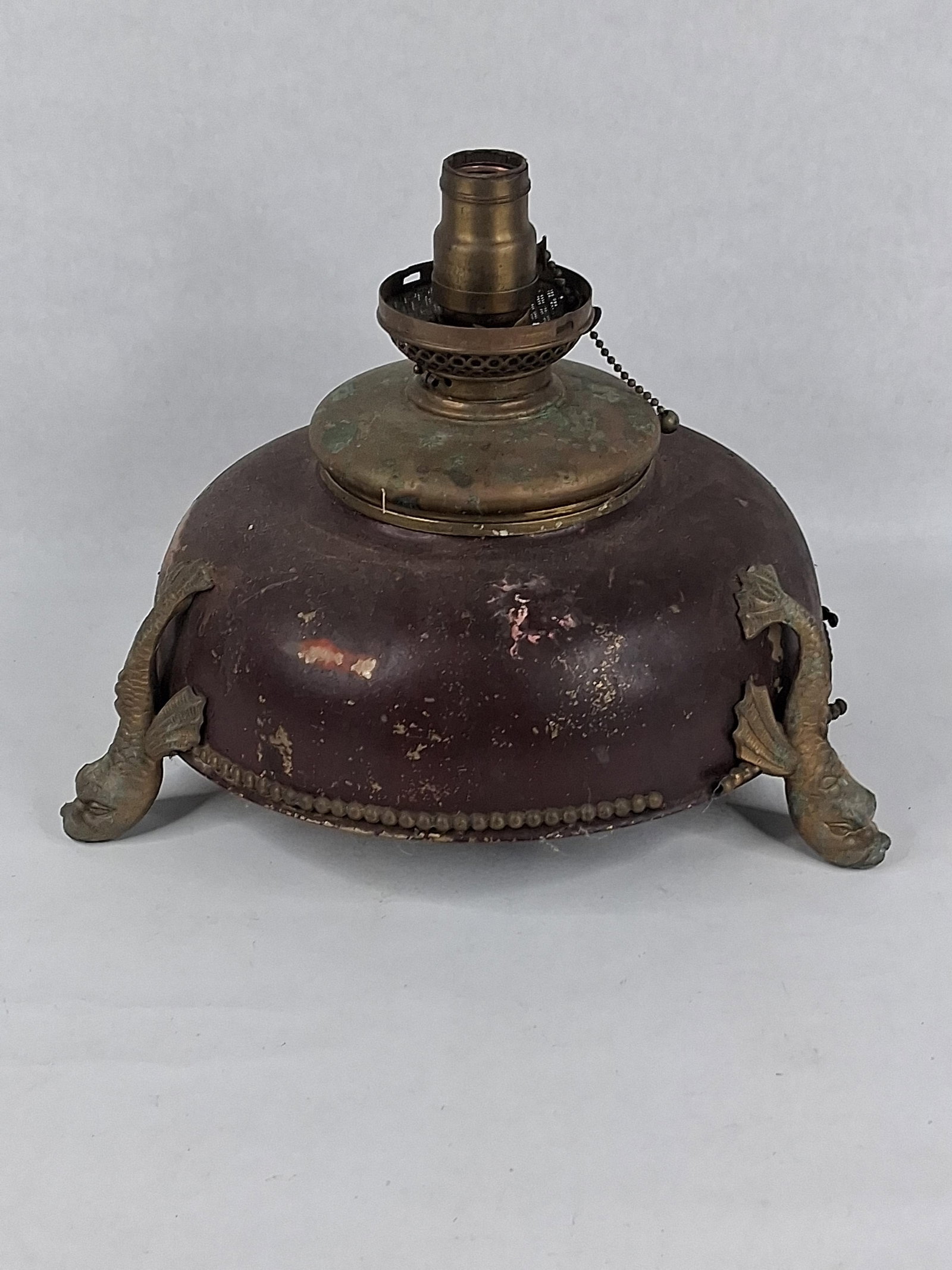 Renaissance Revival Brass Dolphin Lamp Base: 11in dia This antique lamp base is designed in the Renaissance Revival style and features a large, domed metal font cover supported by three cast brass or bronze feet. The domed body is constructed