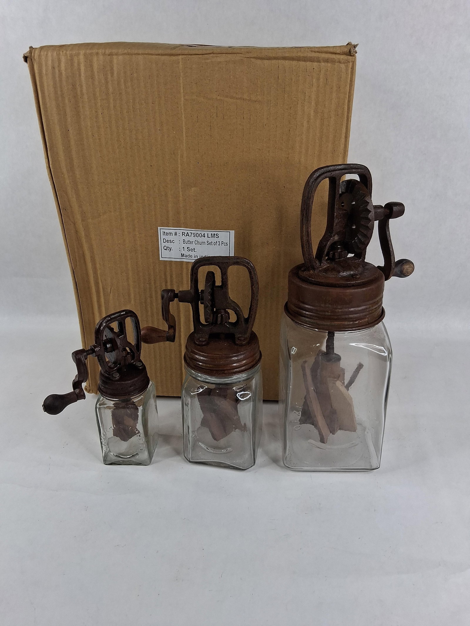 Set 3 Dazey Style Glass & Metal Butter Churns: A set of three decorative glass and metal butter churns in the style of Dazey Churn Co. kitchenware, manufactured in three graduated sizes. Each unit is constructed from a square clear glass jar, a ca