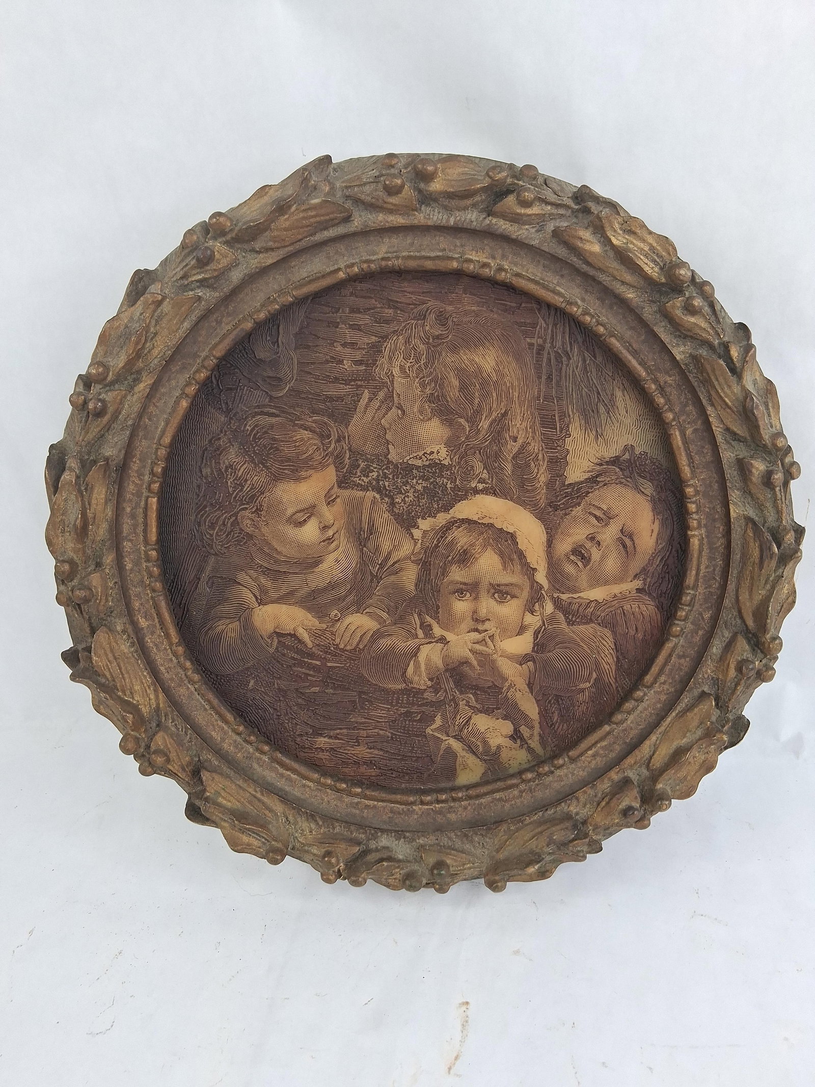 Artini Engraving Resin Relief, Four Children: 13 in dia This circular relief panel is an Artini Engraving produced by Artini Arts, Inc. The piece is constructed from a molded resin or composite material formulated to simulate the appearance of