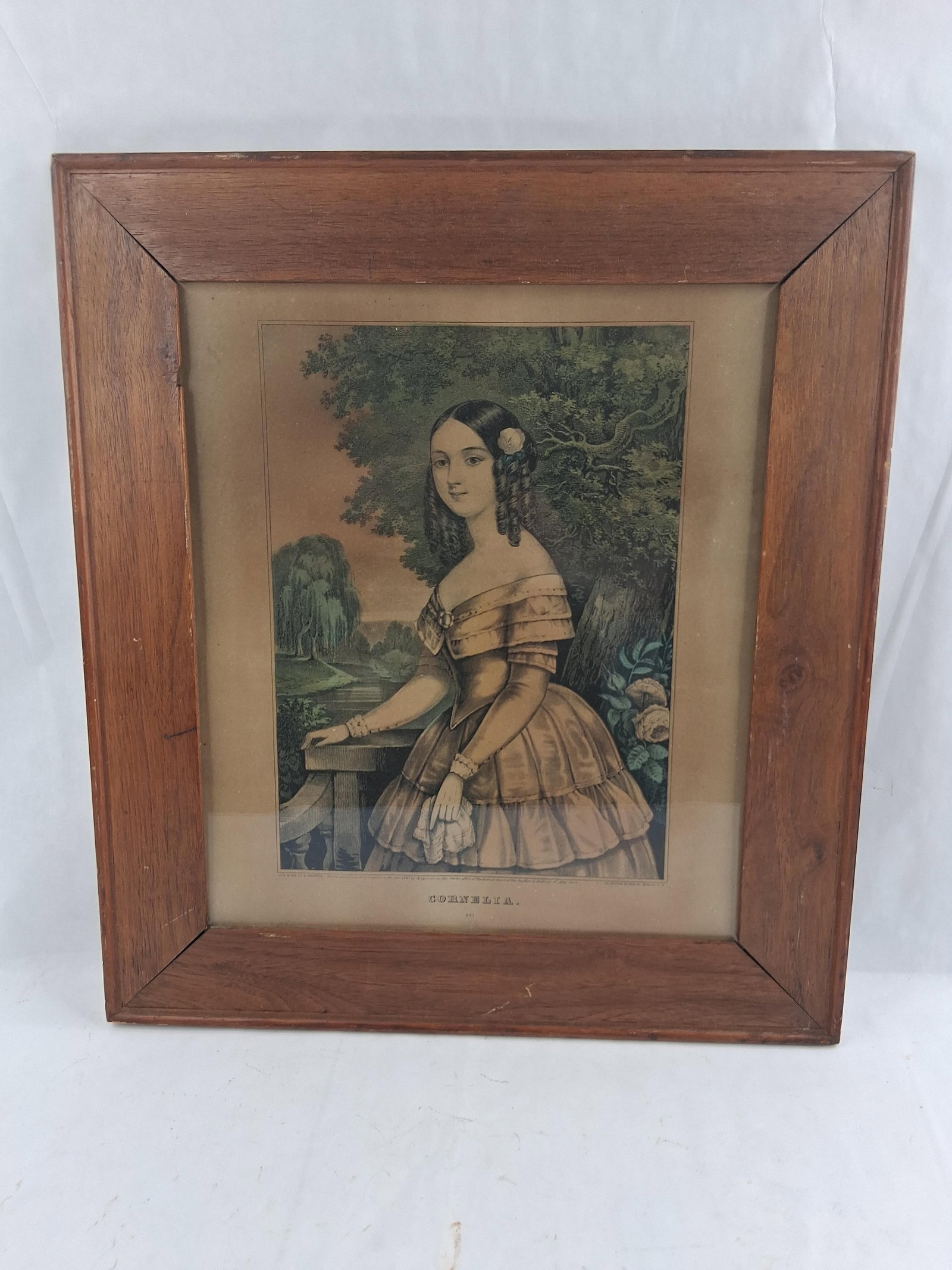 Nathaniel Currier Cornelia Hand-Colored Lithograph: 16x18 This hand-colored lithograph, titled Cornelia, was published by Nathaniel Currier in 1847. The image depicts a young woman in mid-19th-century Victorian attire, featuring an off-the-shoulder