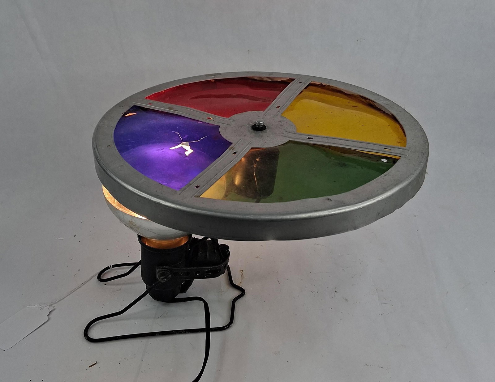 Mid-Century Modern Motorized Color Wheel Spotlight: This is a motorized rotating color wheel lamp, a type of decorative spotlight characteristic of the mid-20th century. This specific design was frequently utilized to illuminate aluminum Christmas