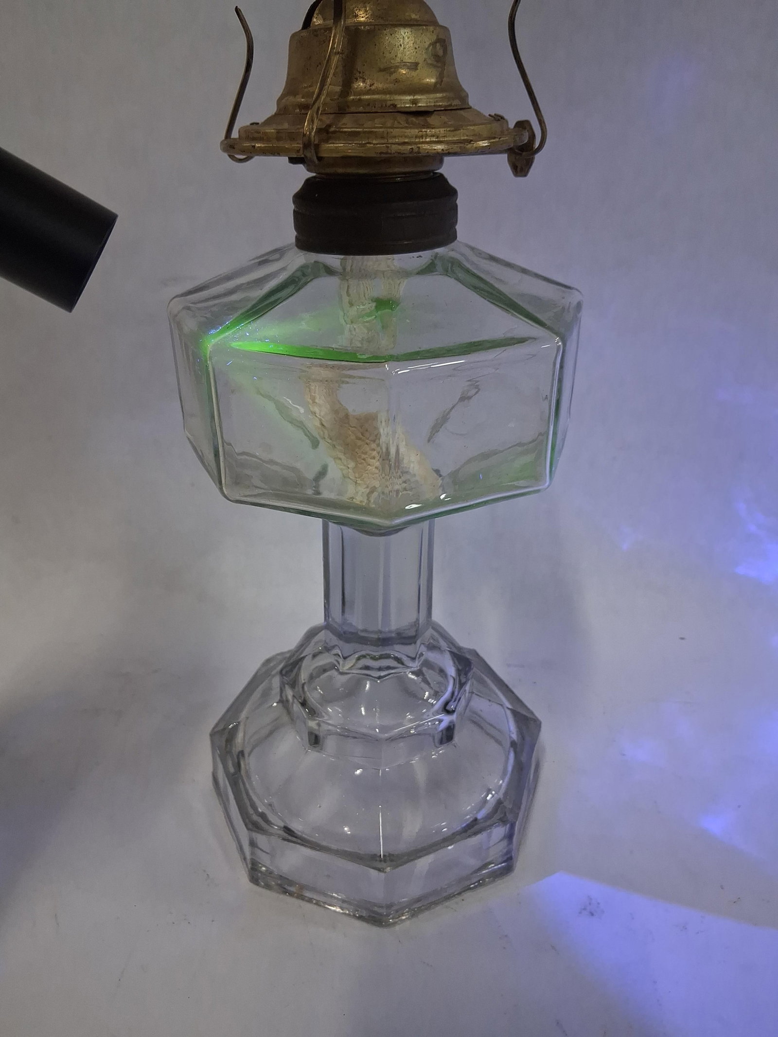 Plume & Atwood Octagonal Pressed Glass Stand Lamp: 11 intall This antique kerosene stand lamp features a clear pressed glass body with a faceted octagonal font and a matching stepped octagonal base joined by a faceted stem. The glass exhibits a