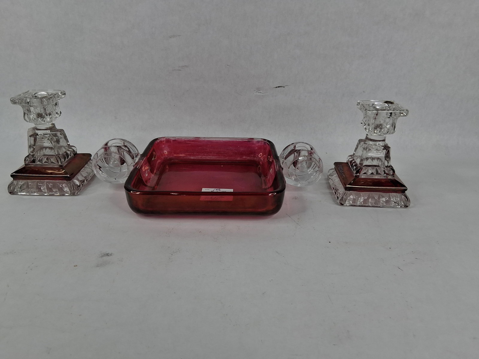 Westmoreland Ruby Flash Pressed Glass Console Trio: Manufactured by the Westmoreland Glass Company of Grapeville, Pennsylvania, this three-piece console set consists of a handled tray and a matching pair of candlesticks. The items are constructed of