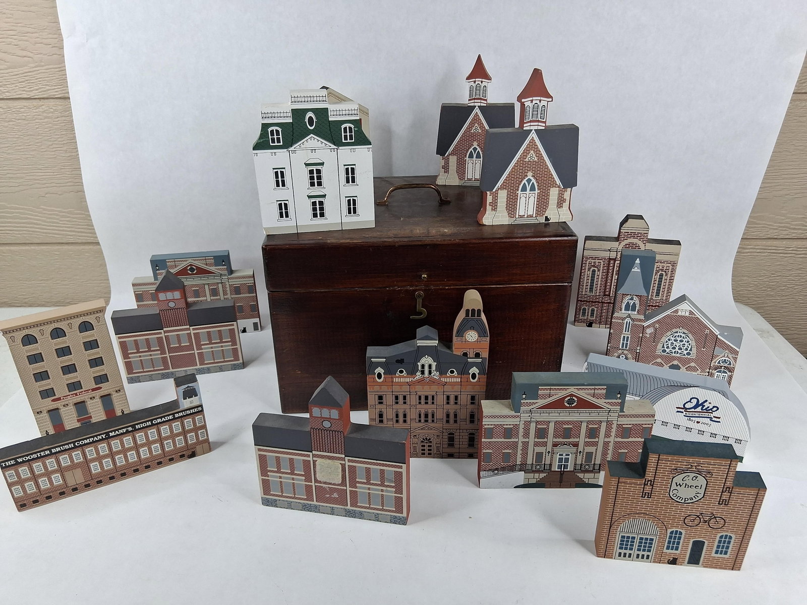 Cat's Meow Village Miniatures w/ Storage Chest: box size 8x9.5x12.5 A collection of screen-printed wooden miniatures from The Cat's Meow Village, depicting historic landmarks and sites in Wooster, Ohio, and the surrounding Wayne County area. The