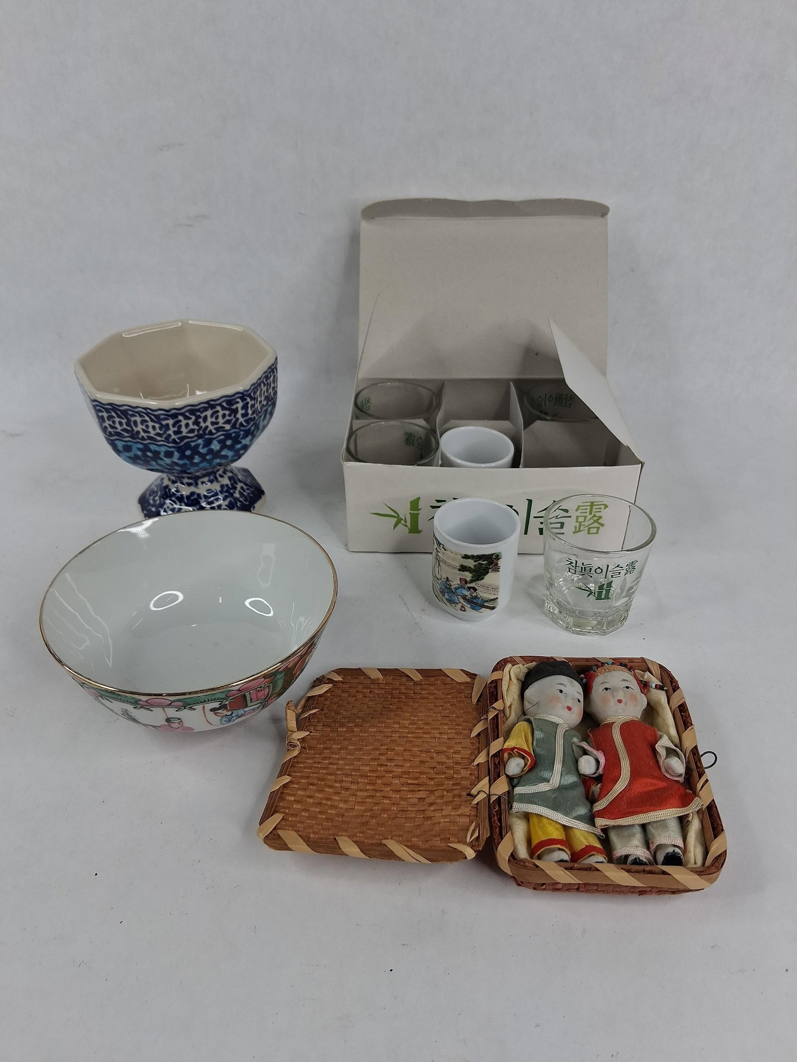 Ceramics, Korean Glassware & Chinese Dolls: This lot features a diverse group of 20th-century decorative objects and ceramics from Korea, Poland, Japan, and China. The collection includes a group of promotional items for the South Korean soju