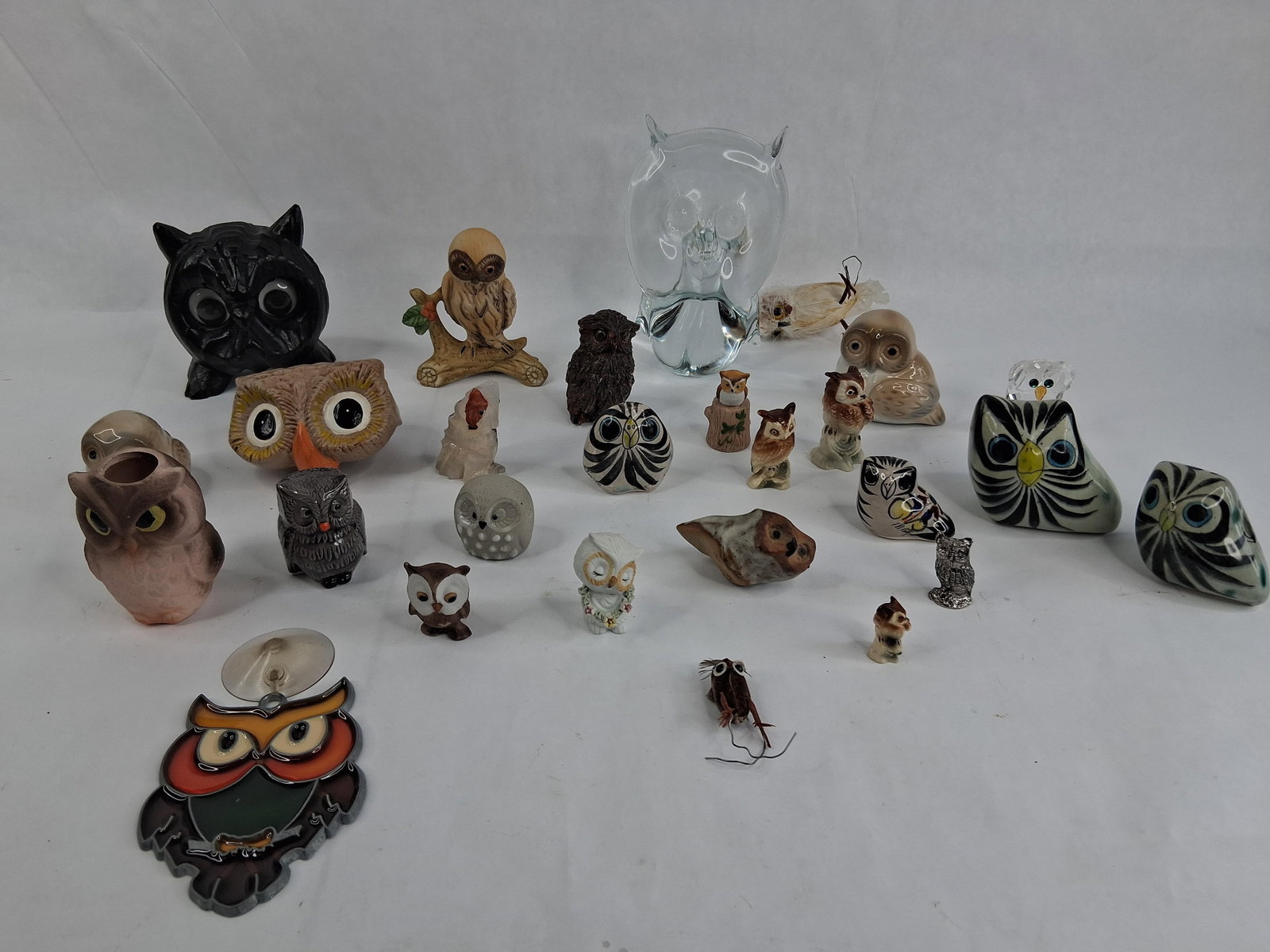 Owl Figurines & Mixed Material Objects: This lot consists of an extensive assortment of owl-themed figurines and decorative items in a wide variety of materials and artistic styles. Included is a large, hand-carved wood owl with a black