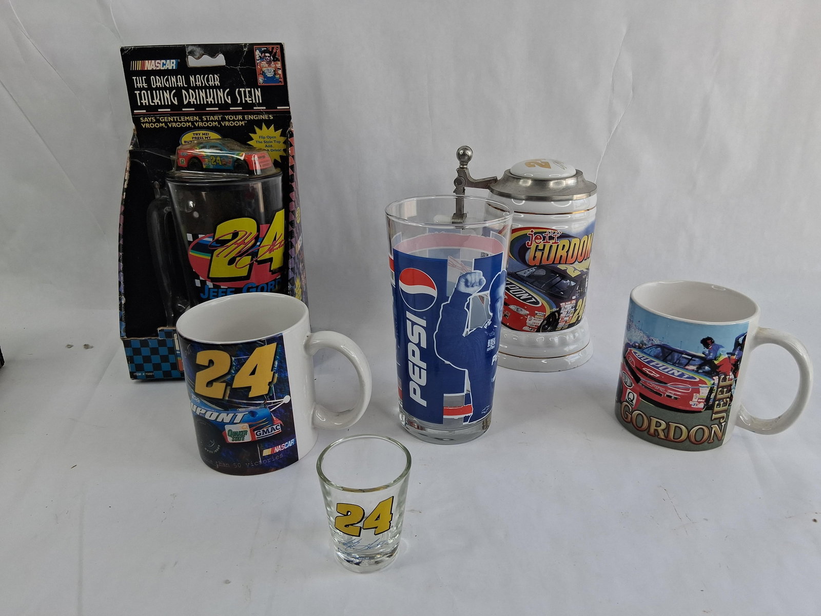 Jeff Gordon NASCAR Memorabilia & Drinkware Set: This group of sports memorabilia commemorates the career of NASCAR driver Jeff Gordon and his tenure with Hendrick Motorsports. The collection comprises six distinct pieces of drinkware and
