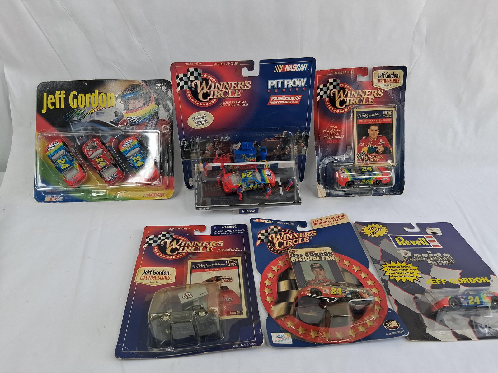 6 Jeff Gordon NASCAR Die-Cast Models: This lot consists of six Jeff Gordon NASCAR die-cast model collectibles, primarily in 1:64 scale. The collection features various editions of Gordon?s iconic #24 Chevrolet, manufactured by Winner's