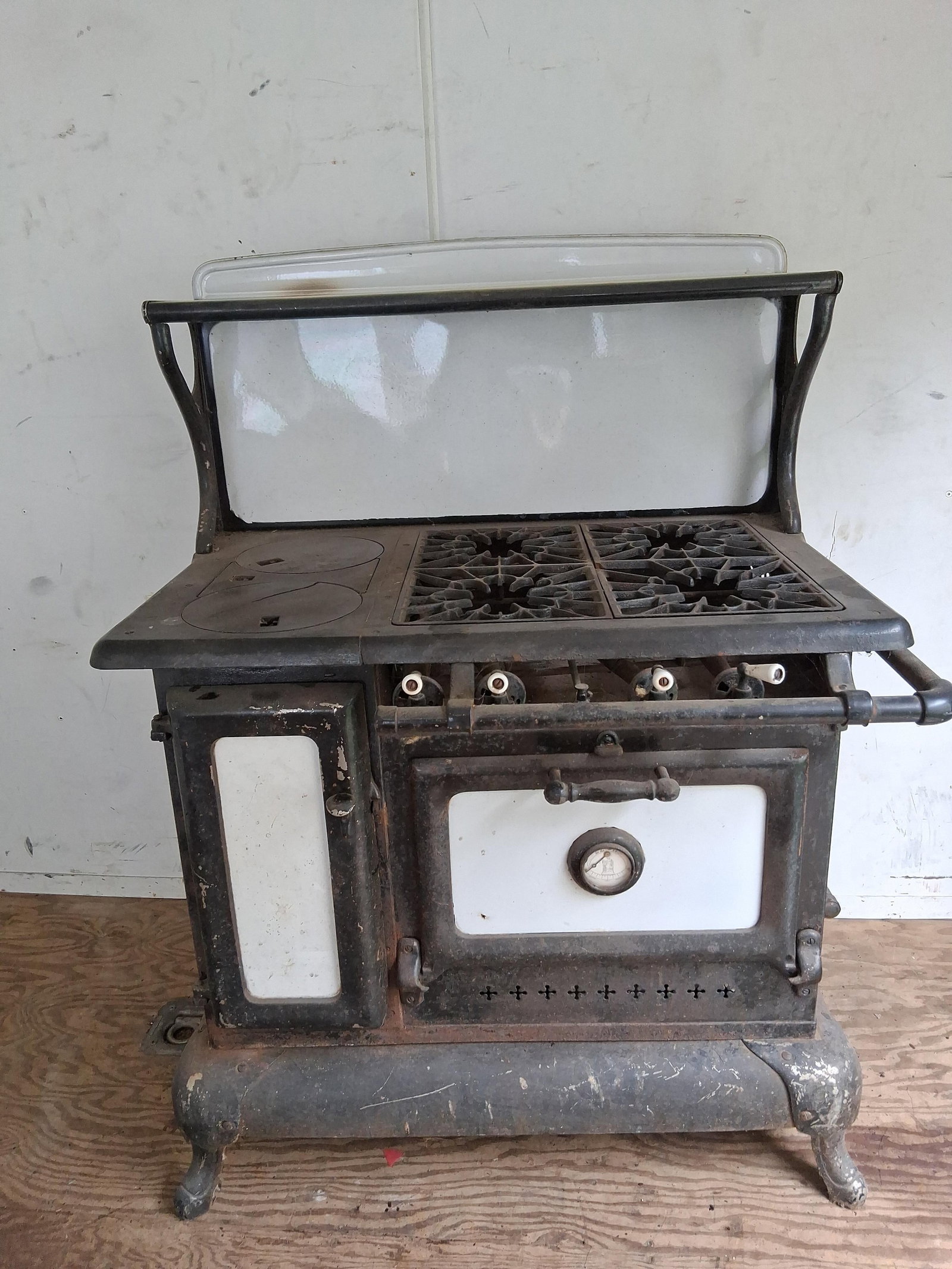 Wehrle Co. Tremont 32-18N Cast Iron & Porc. Stove: 36x26x48 An antique dual-fuel combination cookstove manufactured by The Wehrle Co. of Newark, Ohio. The unit is constructed from heavy cast iron with white porcelain enamel panels on the oven and