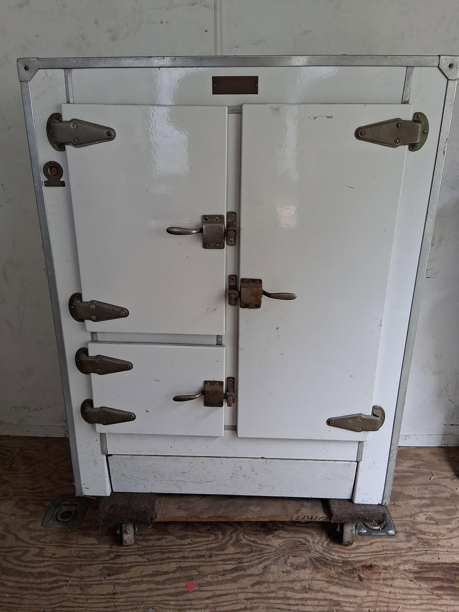 Alaska Refrigerator Co. Four-Door Porc. Icebox: 33x18x43 This antique four-door icebox was manufactured by The Alaska Refrigerator Co. of Muskegon, Michigan. The unit features a white porcelain enamel exterior finish over a wooden frame, with a