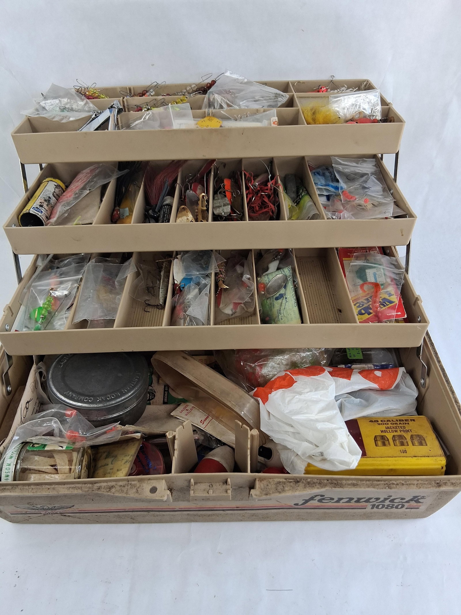 Fenwick 1080 3-Tray Tackle Box w/ Fishing Gear: This Fenwick 1080 Woodstream three tray cantilever fishing tackle box contains a diverse assortment of fishing gear and related accessories. The exterior is constructed from tan colored molded