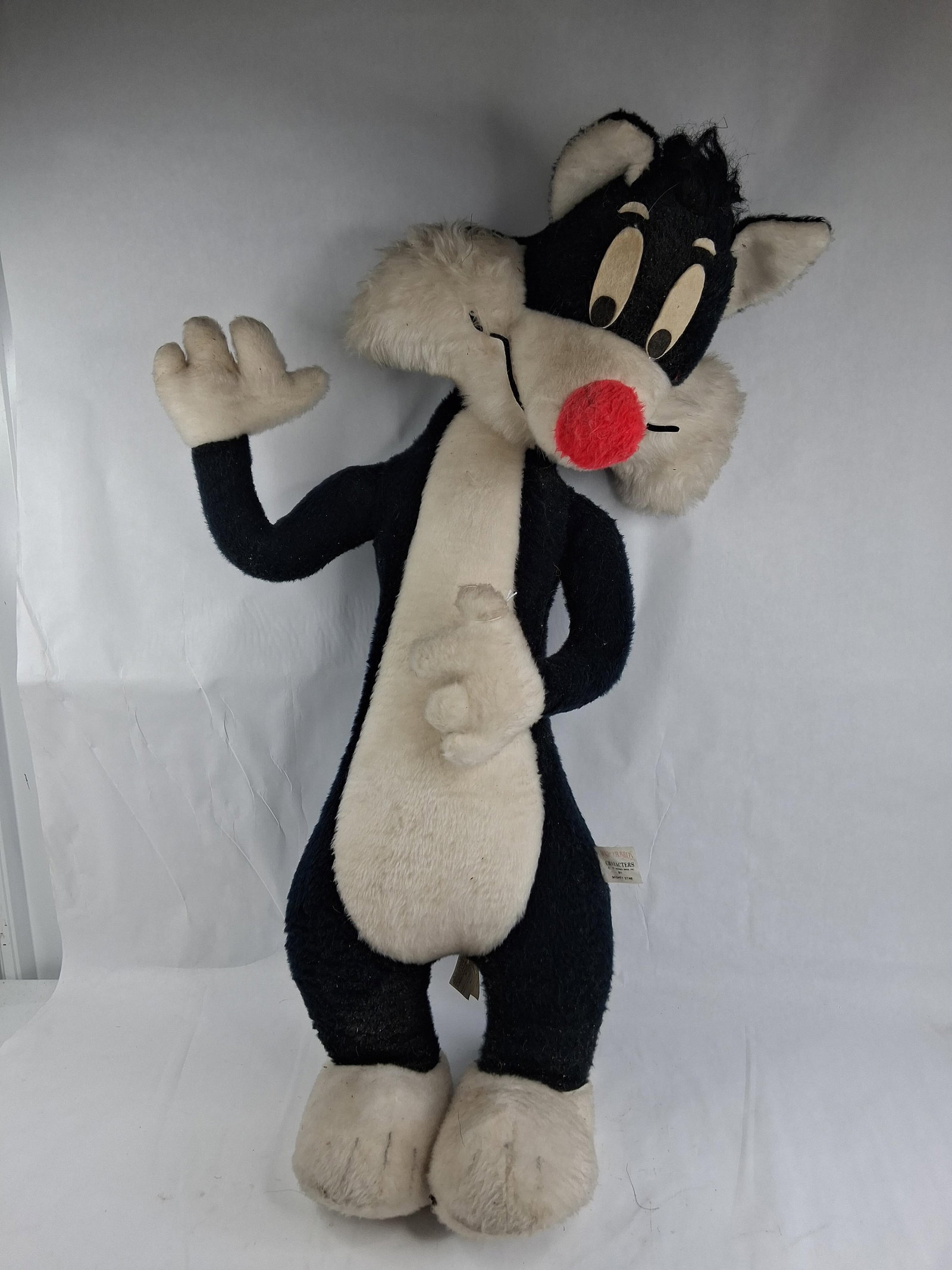 1971 Warner Bros. Mighty Star Sylvester Plush Toy: 36 in tall This large-scale plush figure depicts the character Sylvester the Cat from the Warner Bros. Looney Tunes franchise. The toy is constructed from black and white synthetic plush fabric.