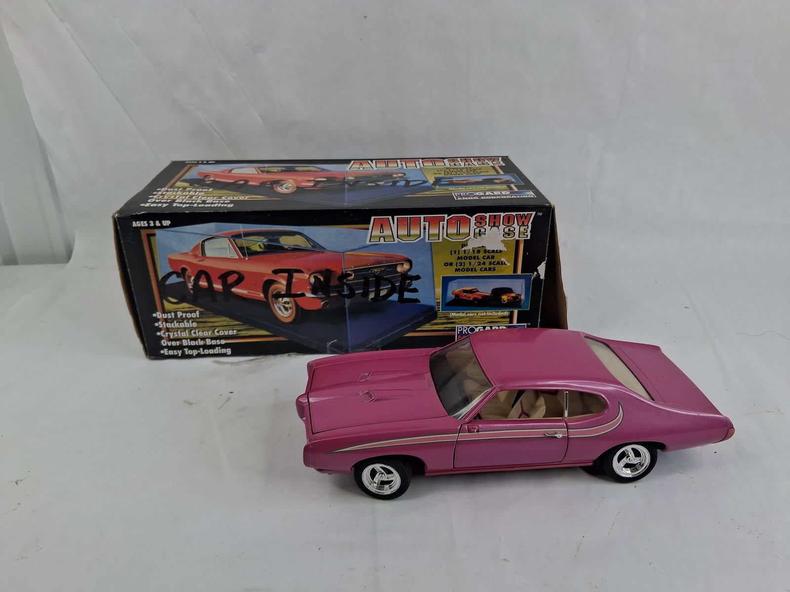Ertl 1/18 Die-cast '69 GTO & '67 Chevelle w/Case: This lot features two 1/18 scale die-cast model cars accompanied by an aftermarket display case and retail box. The first model is a 1969 Pontiac GTO from the Ertl American Muscle Street Machines seri