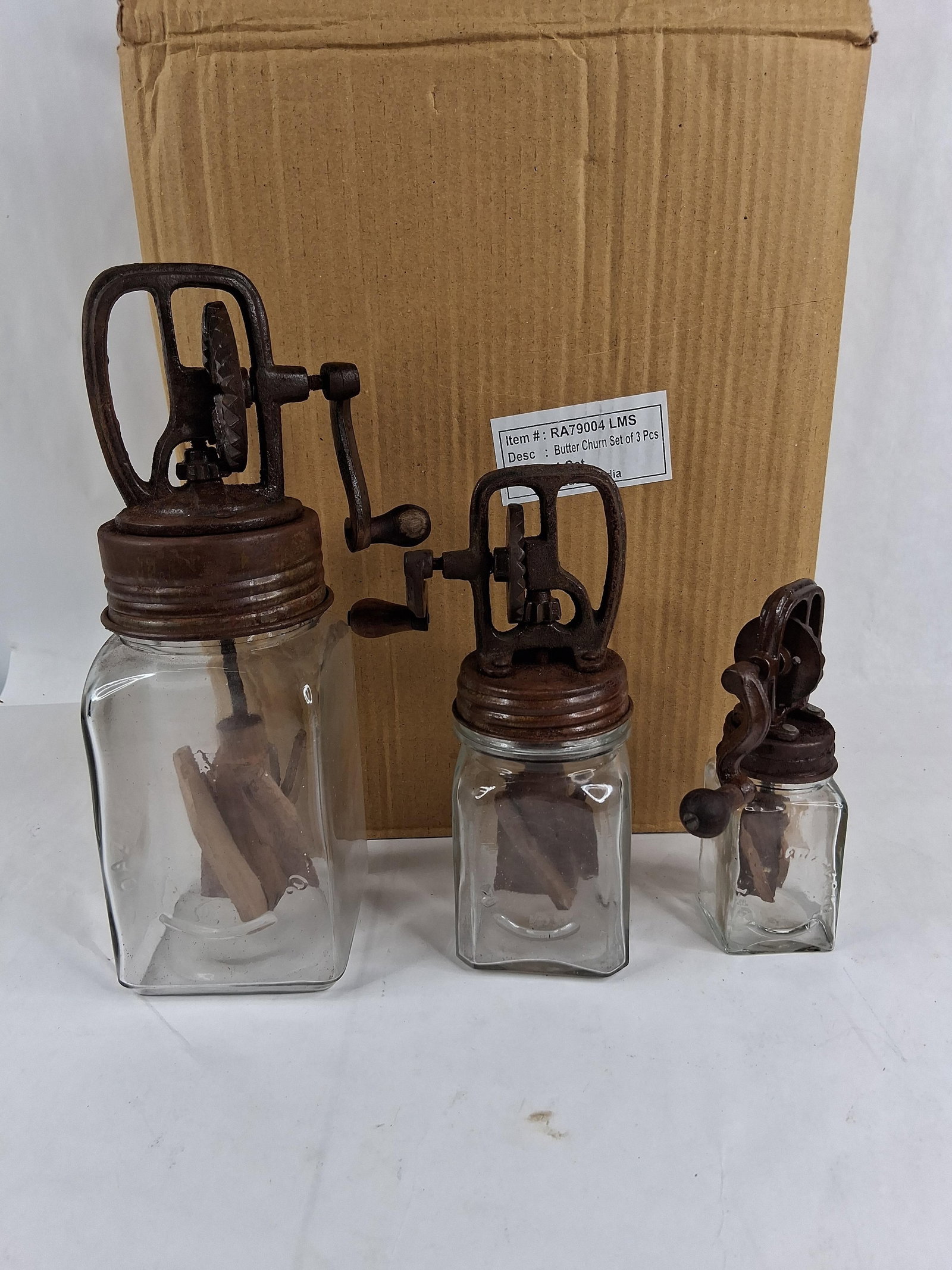 Set 3 Dazey Style Glass & Cast Metal Butter Churns: A set of three graduated decorative butter churns, produced as modern reproductions of early 20th-century American farmhouse kitchenware. The collection includes a large, medium, and small unit, each