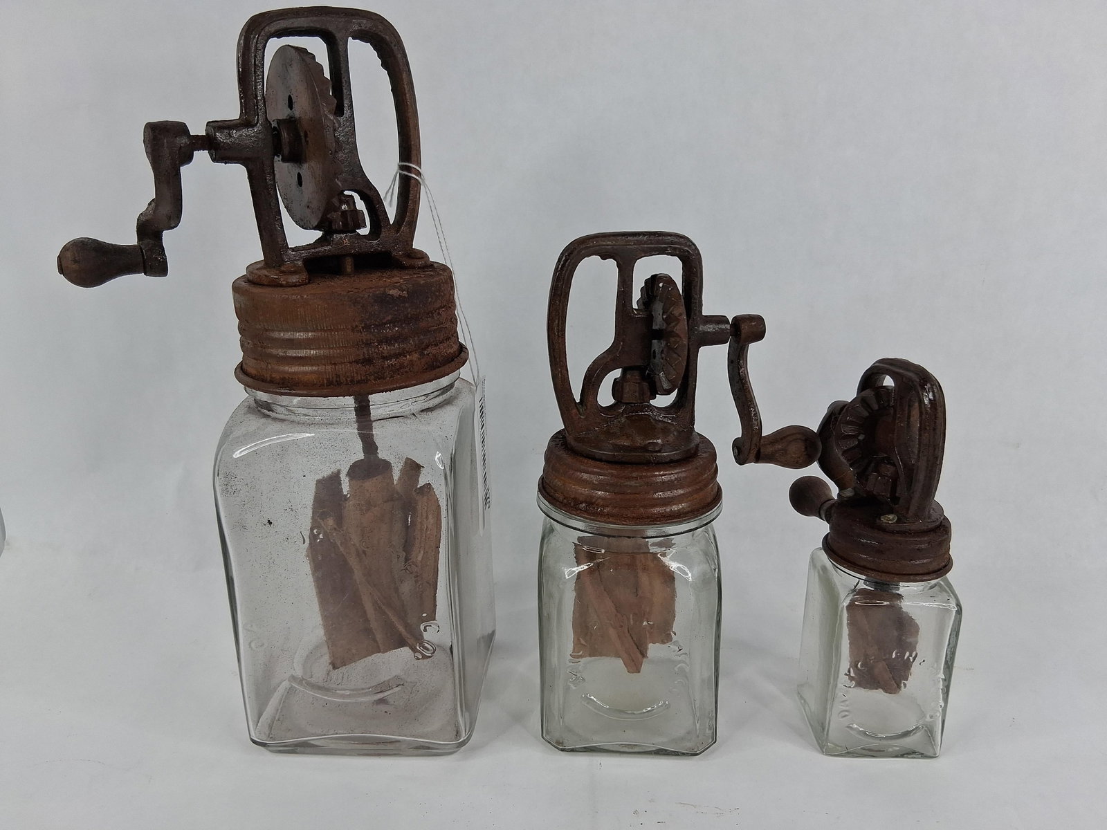 3 Antique Dazey Glass Butter Churns, 10, 20 & 40: A trio of antique Dazey Churn & Mfg. Co. manual glass jar butter churns. This graduated collection includes three different sizes identified by model numbers 10, 20, and 40. Each churn consists of a s