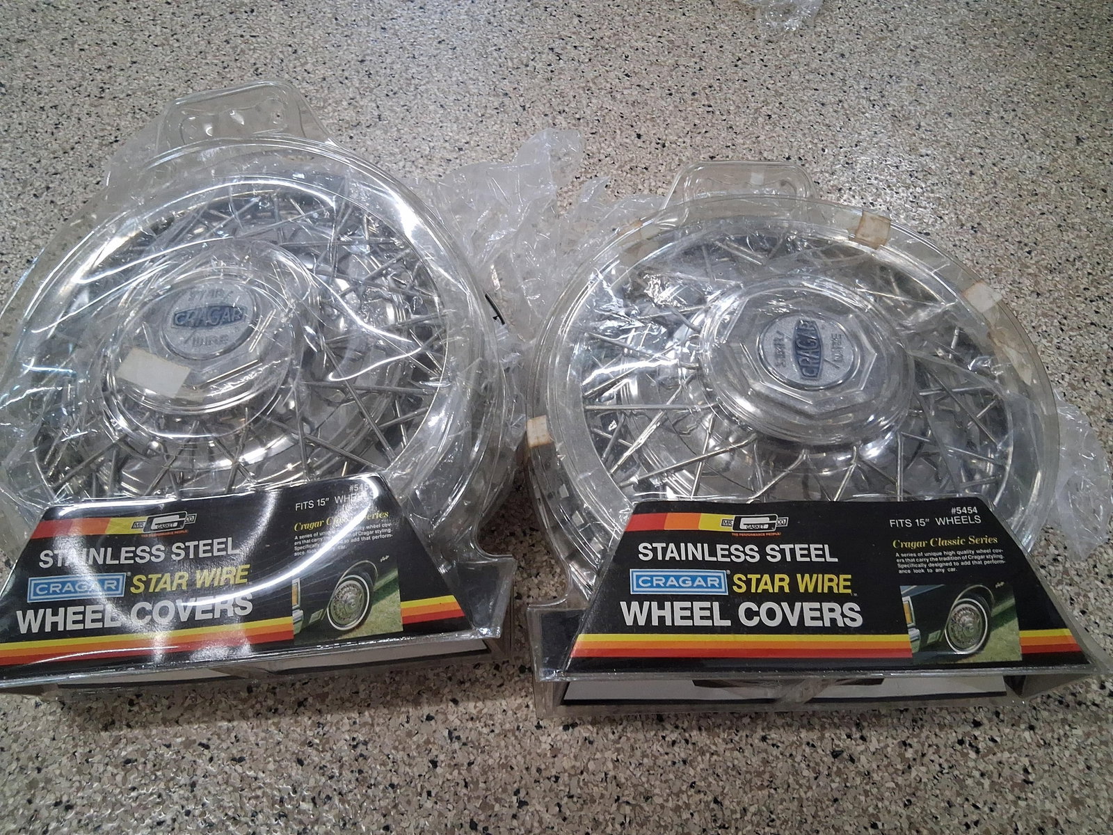 Pair Cragar Star Wire Classic Wheel Covers: A pair of aftermarket wheel covers from the Cragar Classic Series, specifically the Star Wire model, part number 5454. These units are designed to fit 15 inch wheels and are constructed from