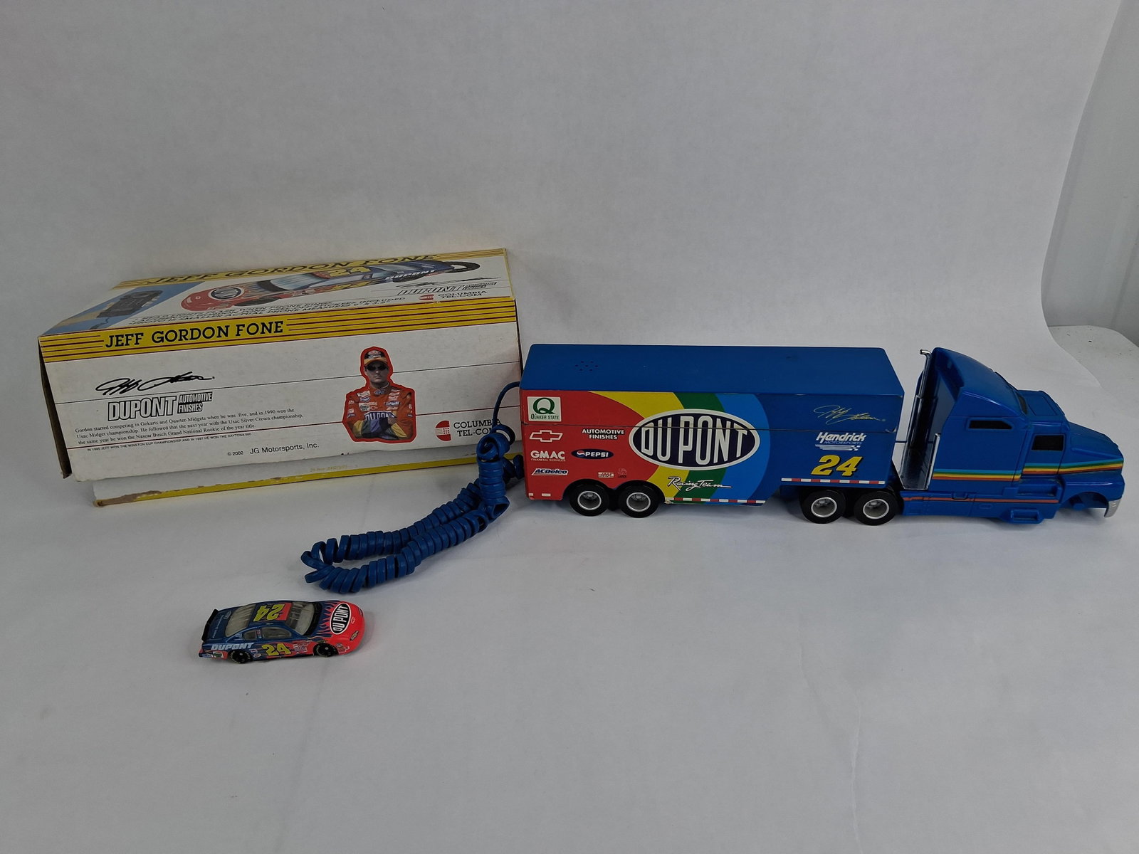 Jeff Gordon #24 DuPont Telephones & Memorabilia: A collection of NASCAR memorabilia related to Hall of Fame driver Jeff Gordon and the Hendrick Motorsports number 24 team. The group features two different novelty landline telephones produced by